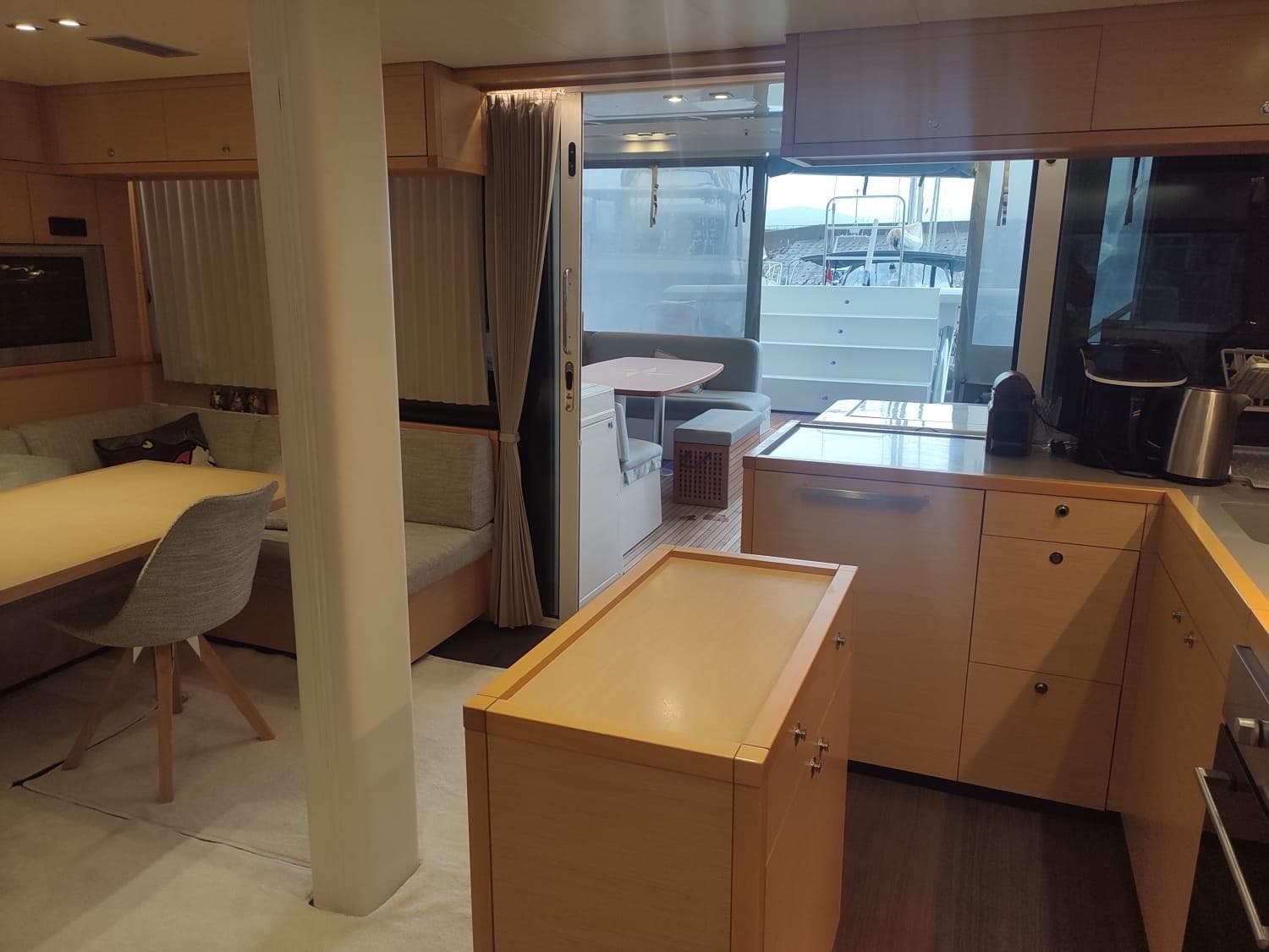 Luxurious interior of a 2014 Lagoon 52 yacht featuring modern kitchen and dining area.