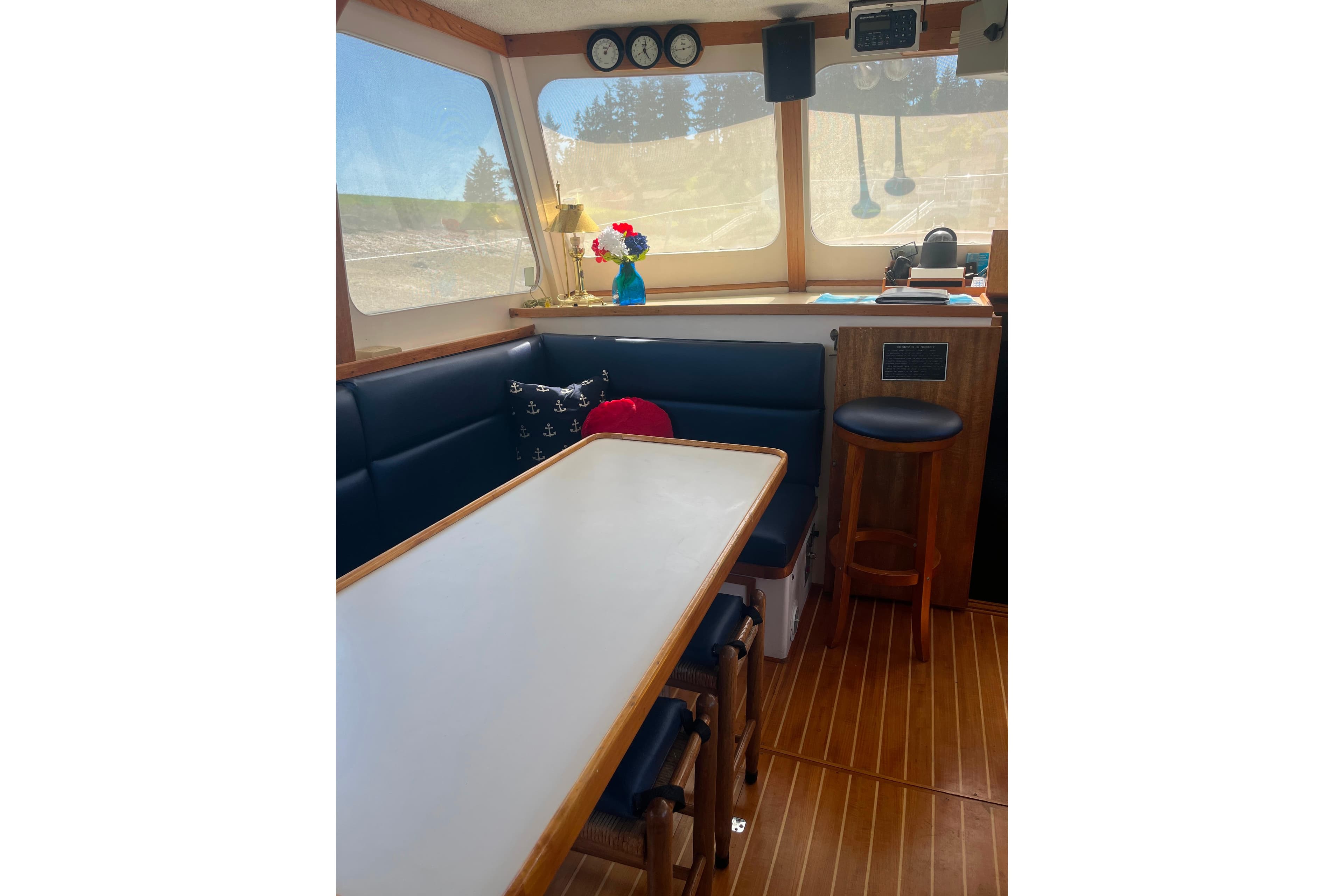 Interior of 1972 DeFever 38 Passagemaker with dining area and nautical decor.