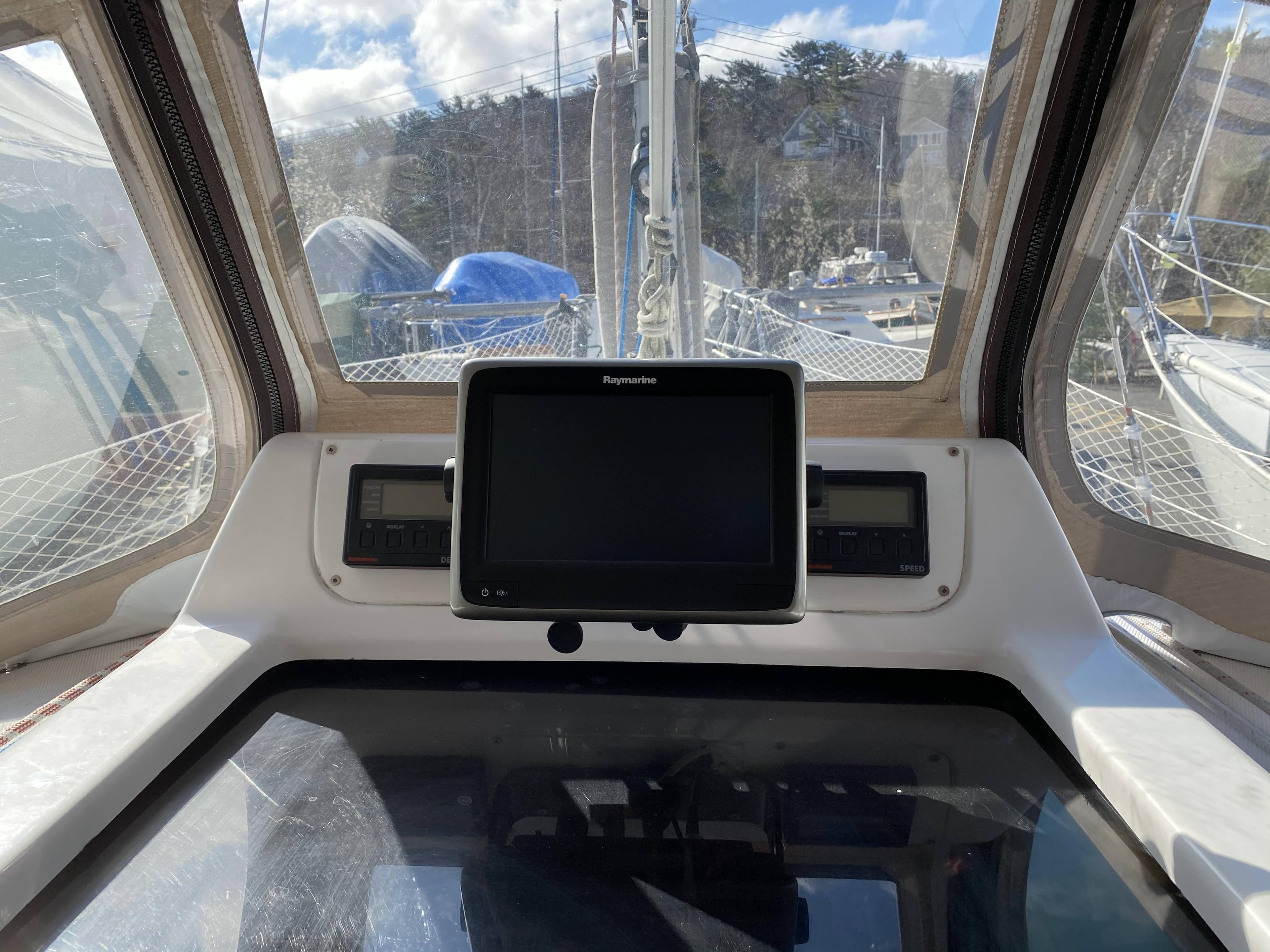 Cockpit view of a 2001 Hunter 320 sailboat with navigation equipment.