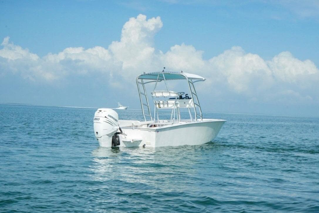 2016 Rambo 27 boat on calm ocean with blue sky and clouds.
