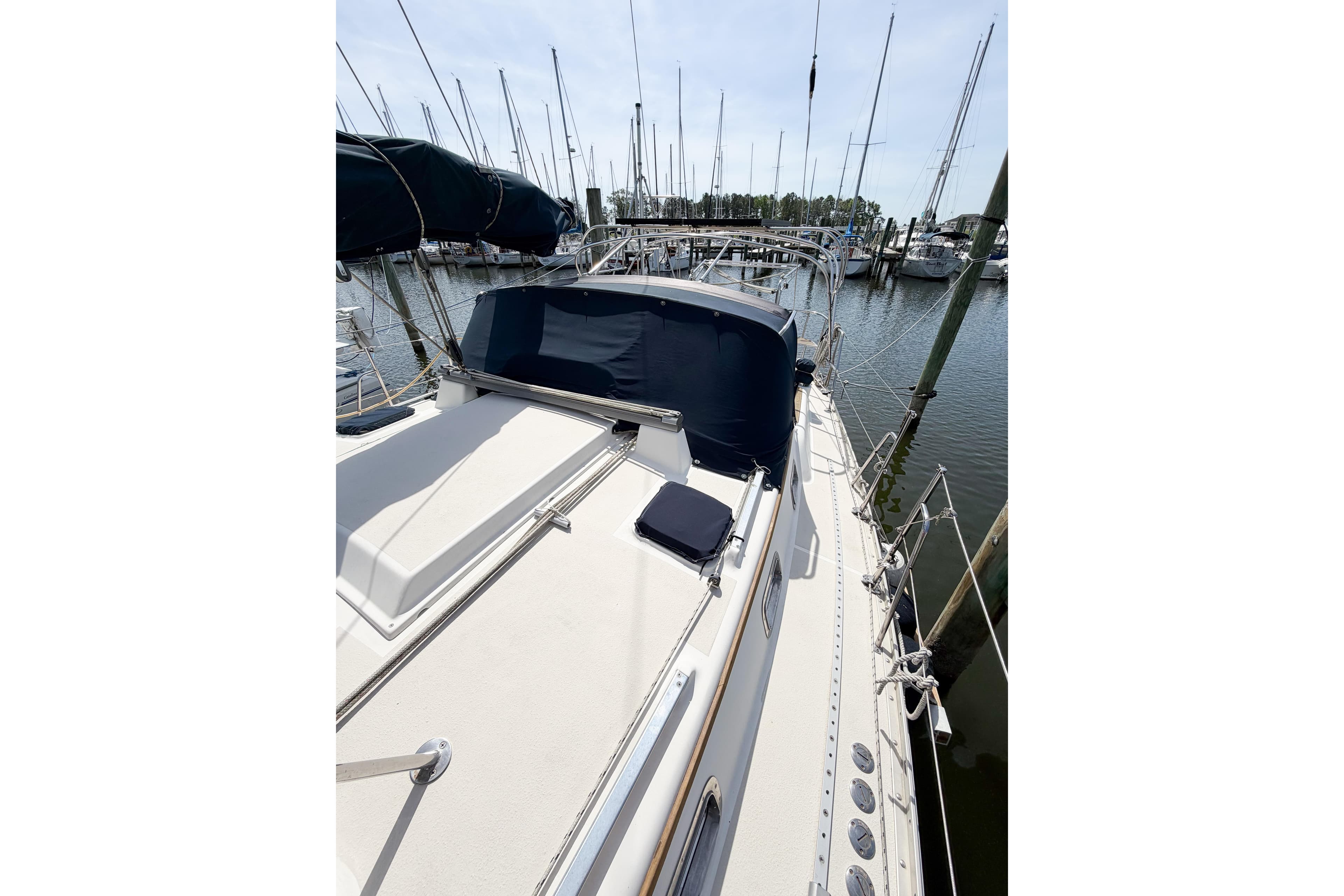 2001 Caliber 40LRC sailboat docked at marina, featuring sleek deck design and covered cockpit.