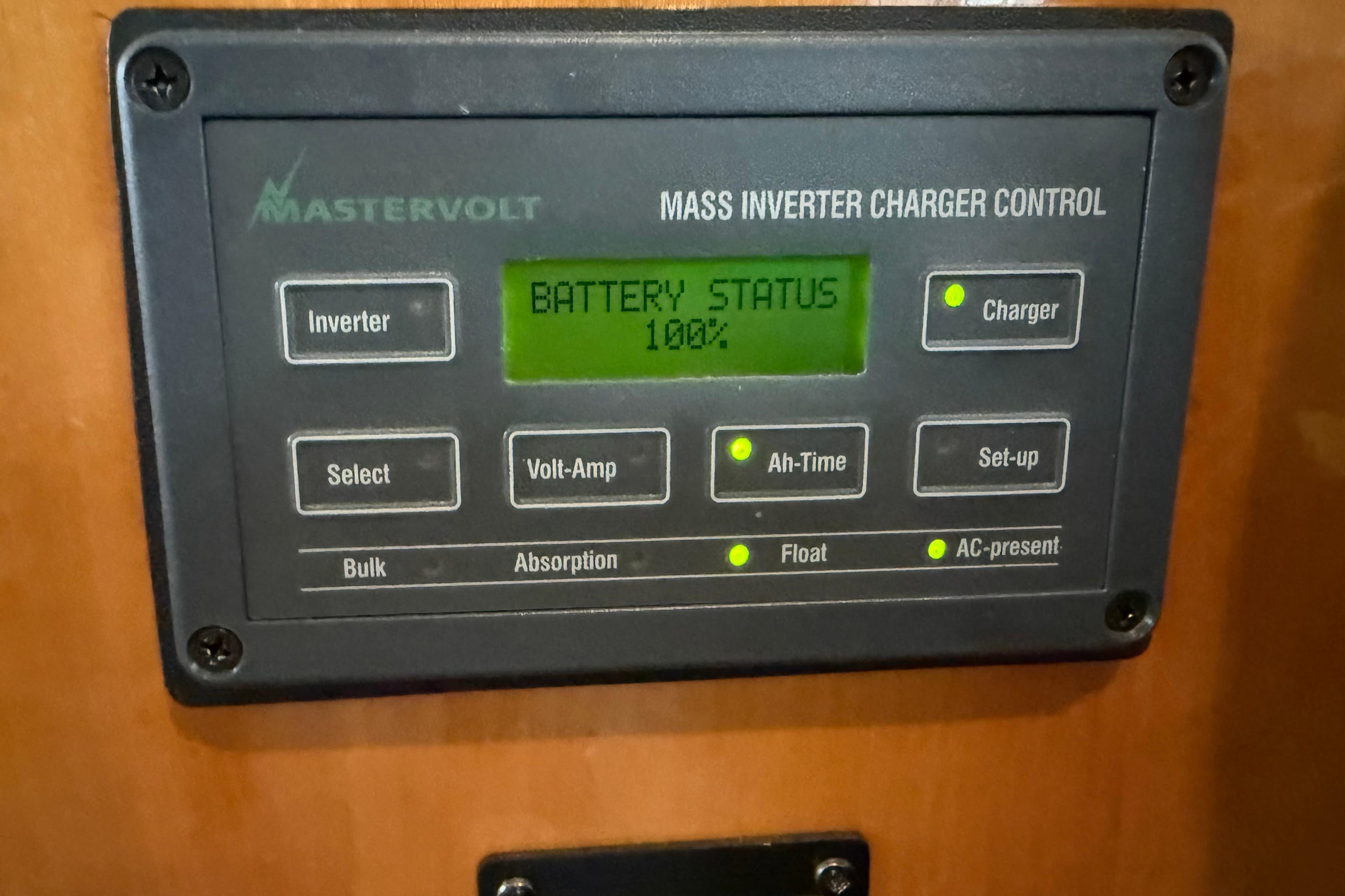 Mastervolt inverter charger control panel on 2000 Novatec Cockpit Motor Yacht, showing 100% battery status.