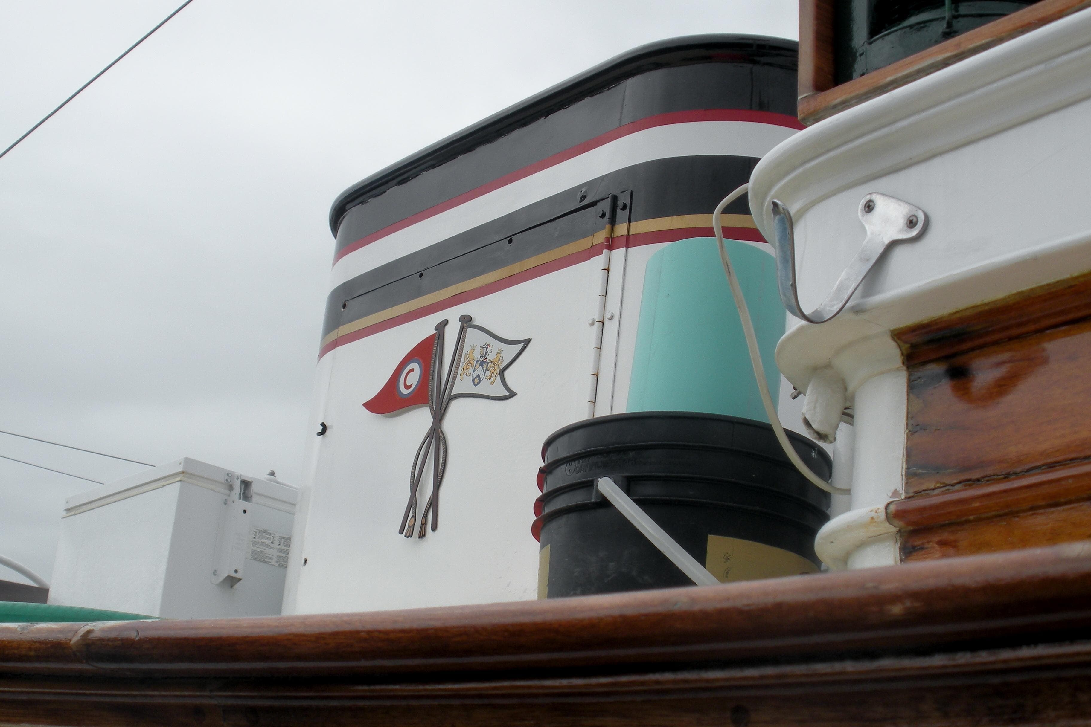 Alt text: 1929 Custom HOFFAR-BEECHING Fantail Yacht with detailed emblem on the side.