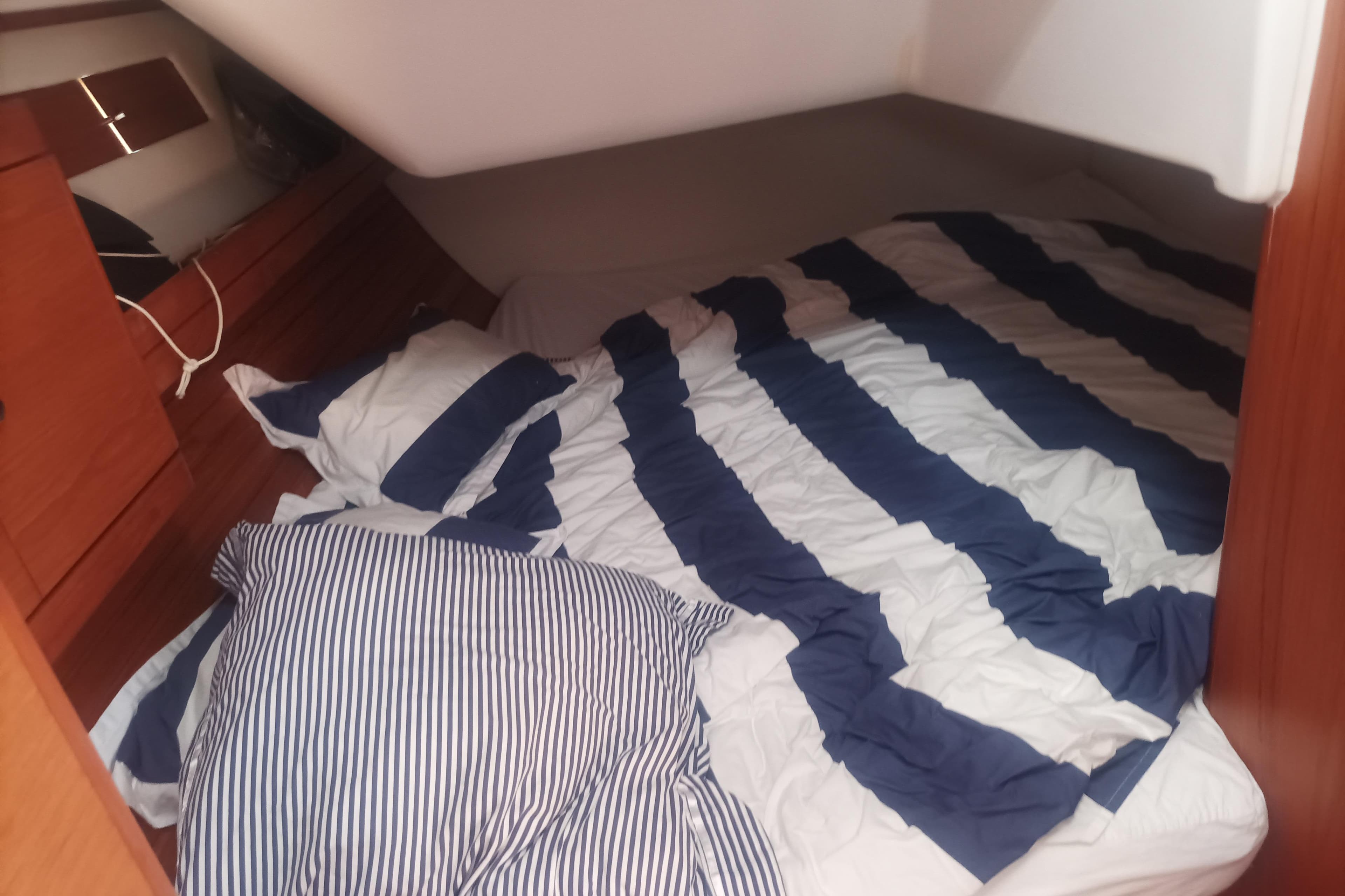 Cozy cabin interior of 2013 Wauquiez CENTURION 40S.2 with striped bedding.