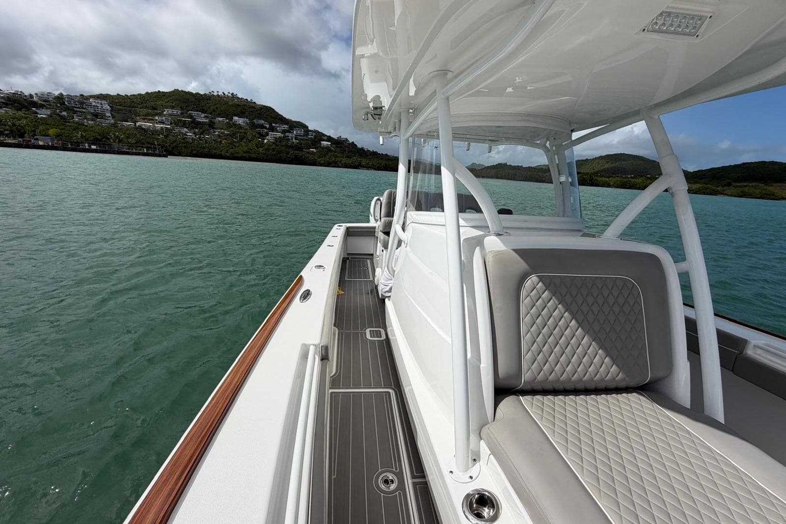 2021 Valhalla Boatworks V-33 on calm water, showcasing sleek design and luxurious seating.