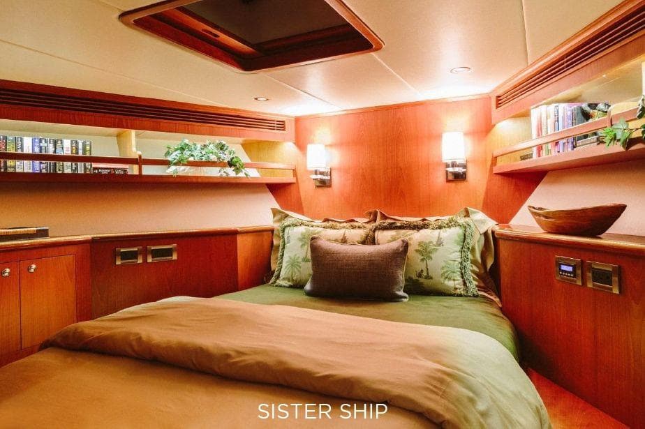 Luxurious cabin interior of 2027 Outer Reef Yachts 880 Cockpit Motoryacht, featuring elegant wood finishes.