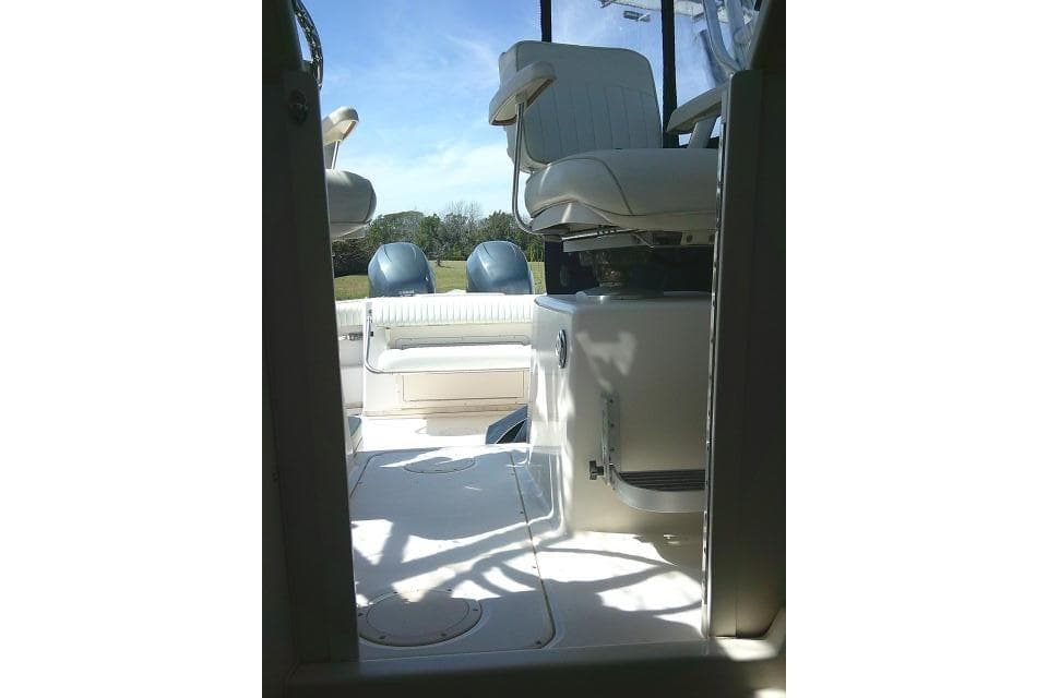 2004 Grady White 27 Islander boat interior with seating and clear sky background.