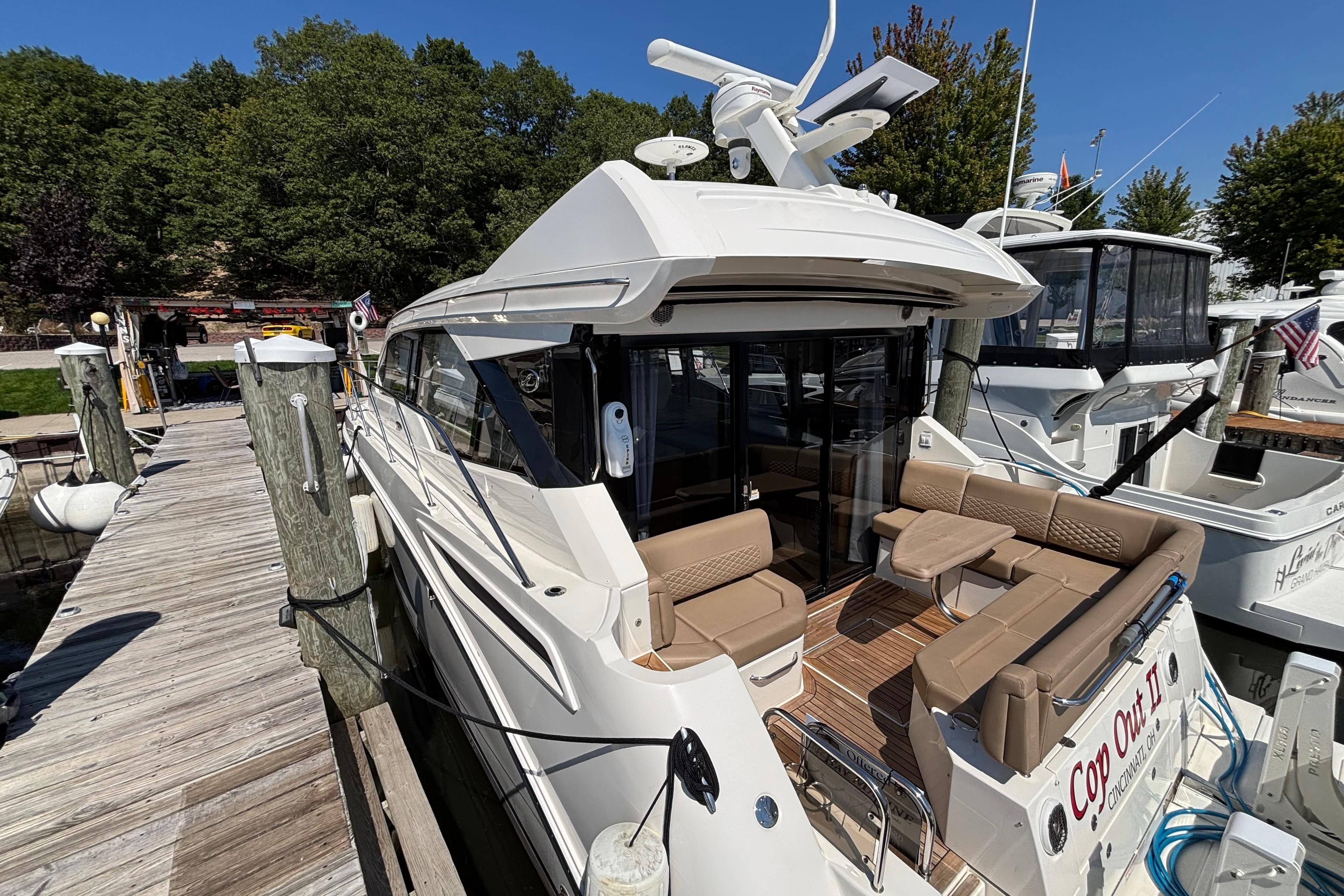 2018 Sea Ray Sundancer 460 yacht docked, featuring spacious seating and sleek design.