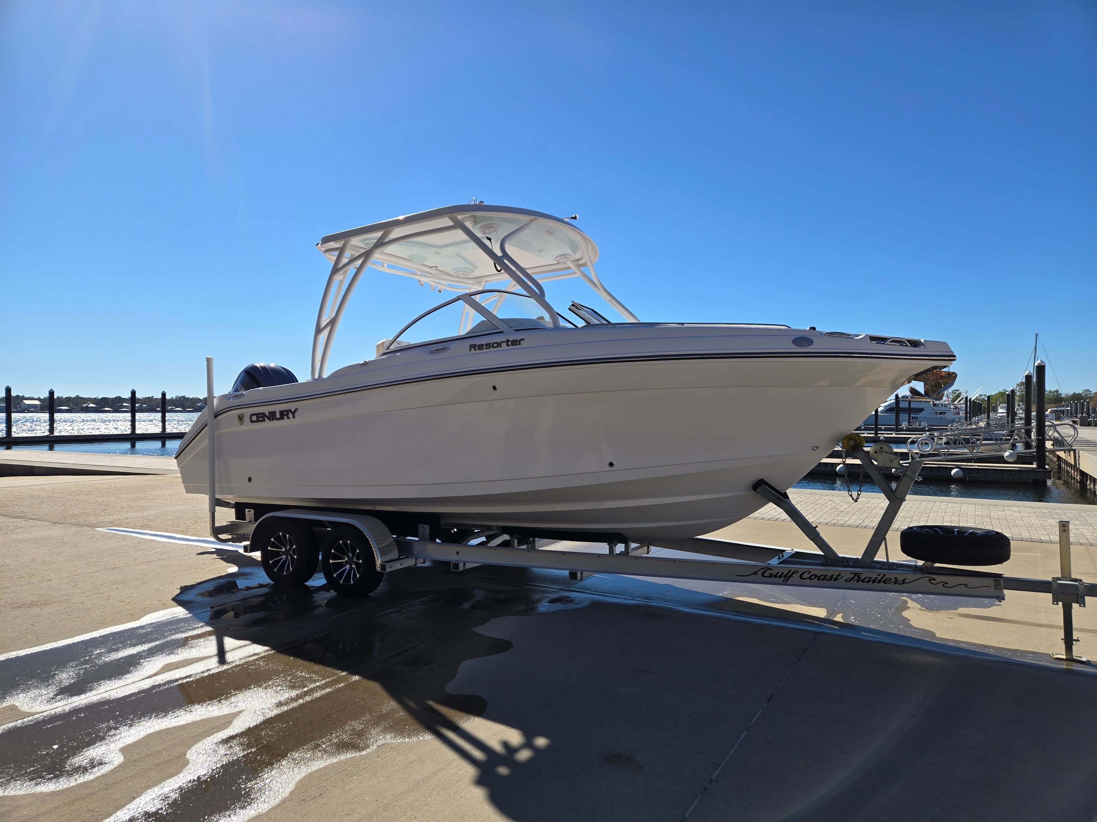 2024 Century 24 DC boat on trailer at dock.