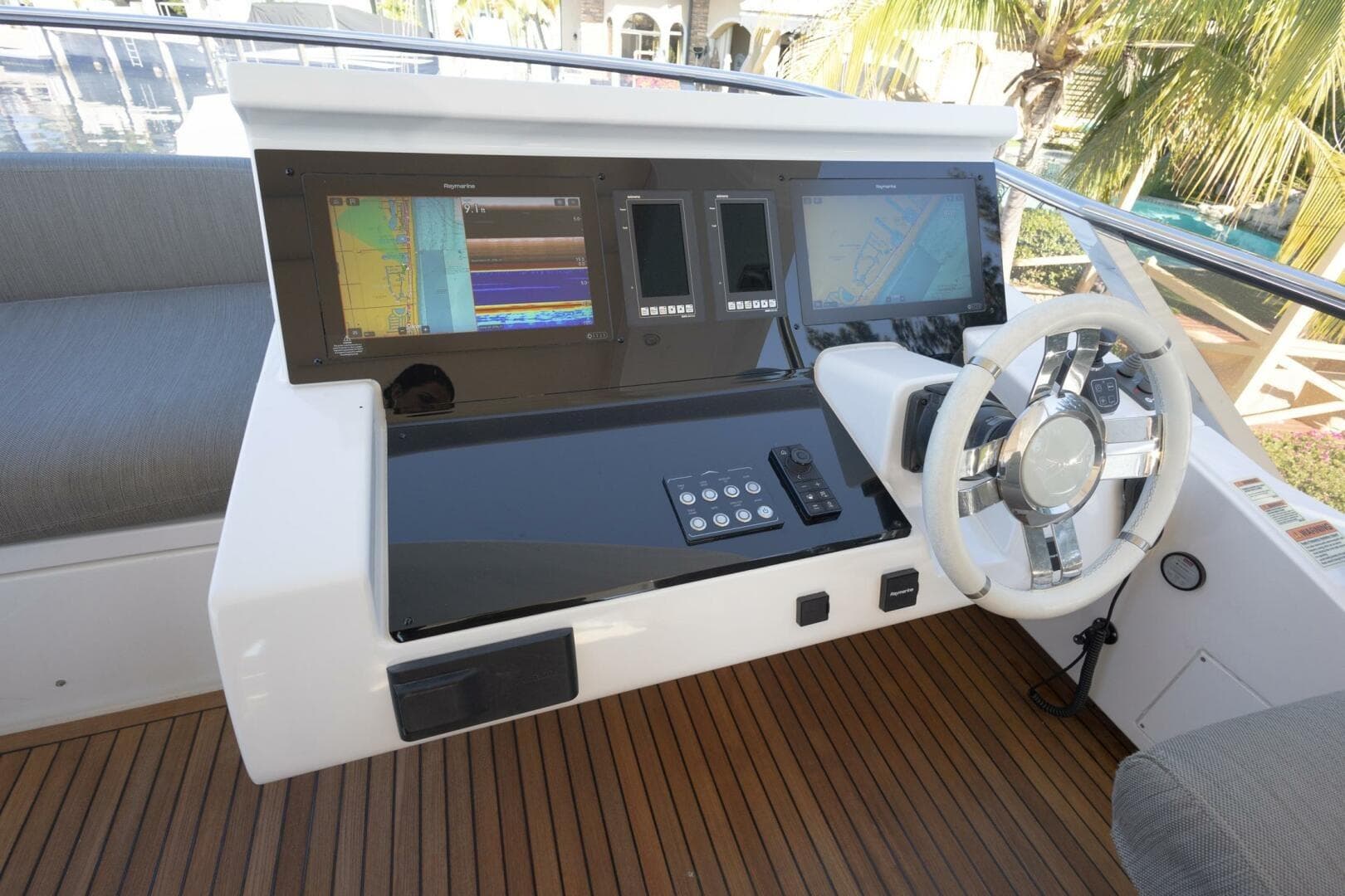 Cockpit of 2021 Azimut Fly 72 yacht with modern navigation displays and steering wheel.