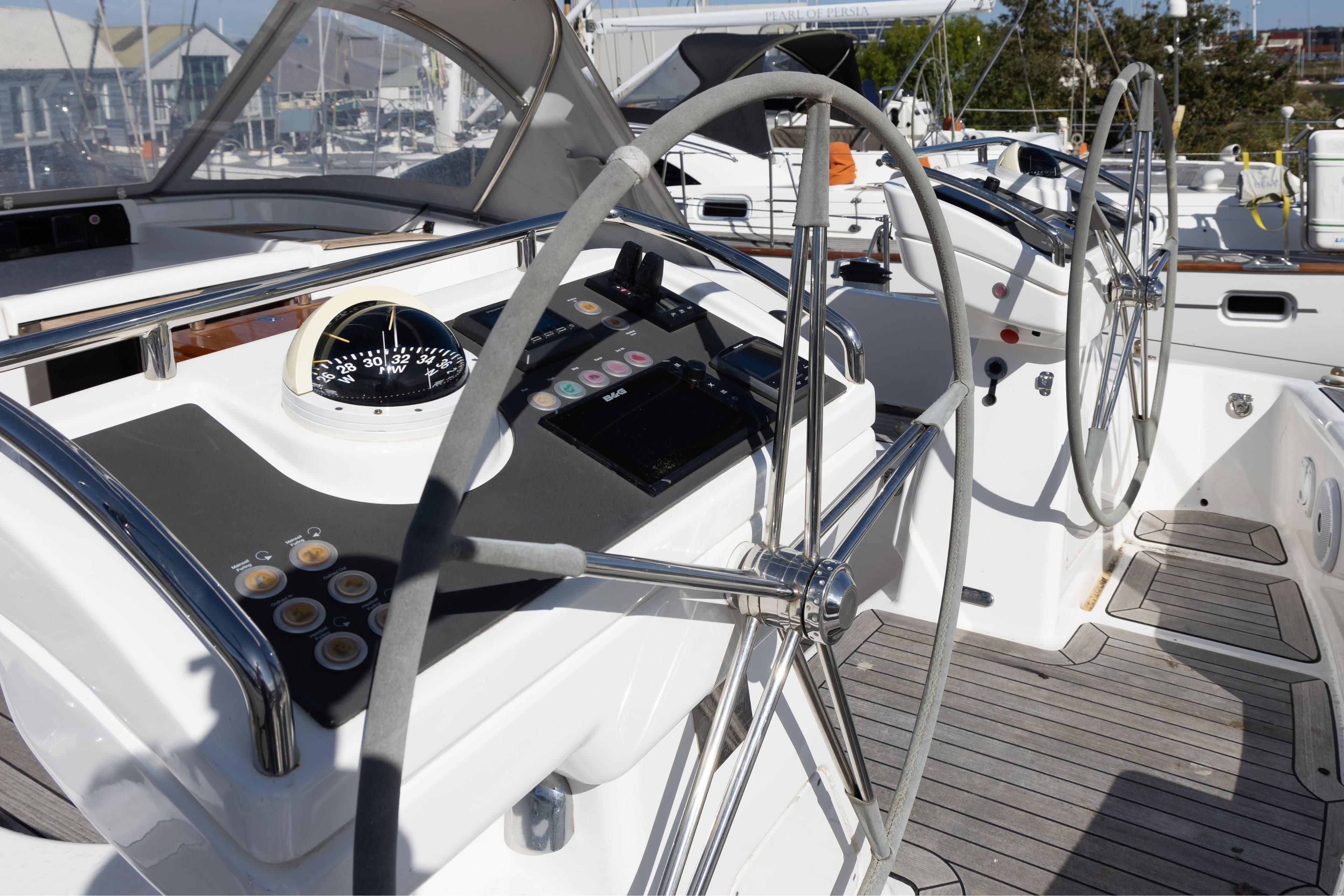 Cockpit of 2016 Oyster 575 yacht with dual steering wheels and navigation instruments.