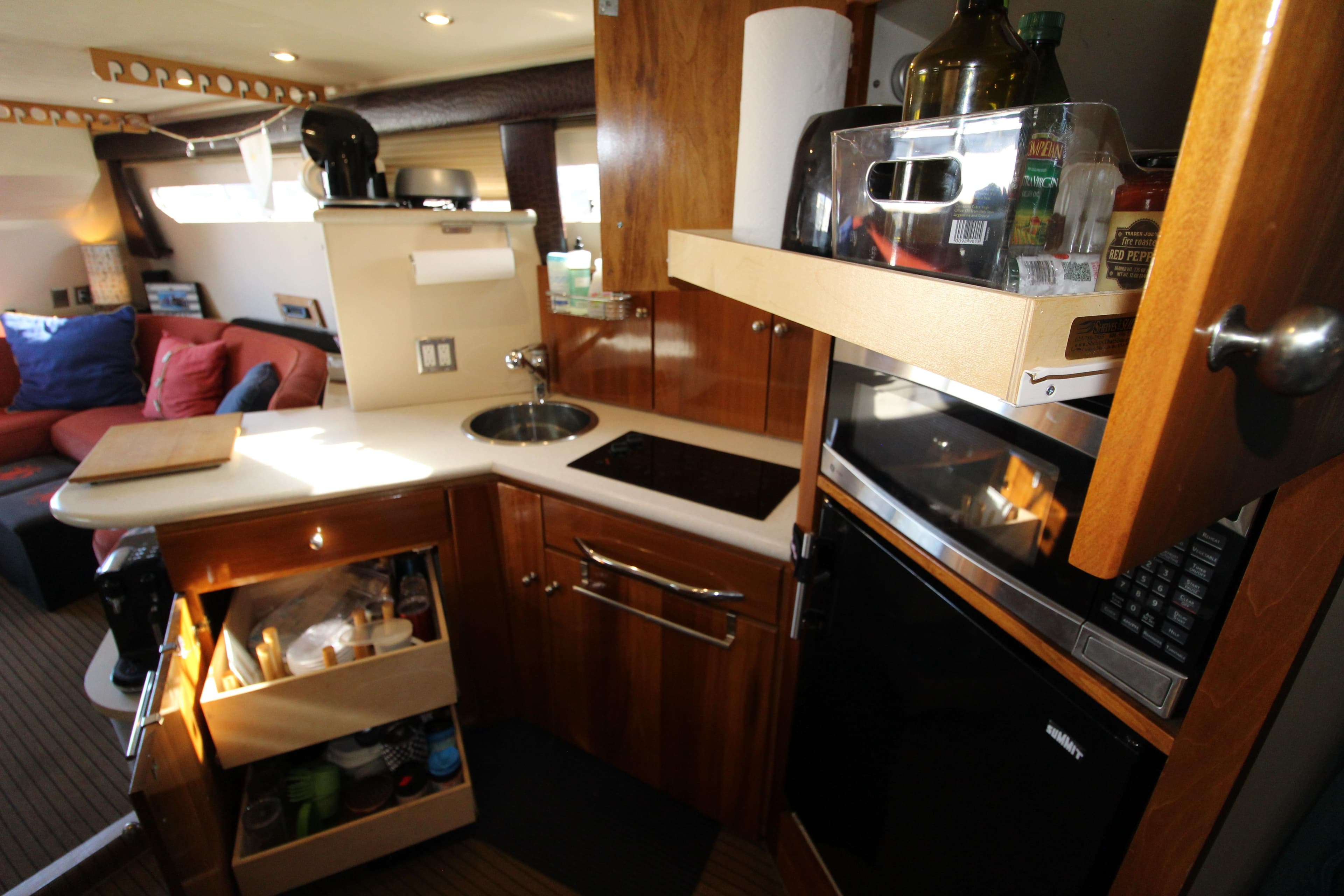 1990 Carver 3467 Santego yacht interior kitchen with wooden cabinets and modern appliances.