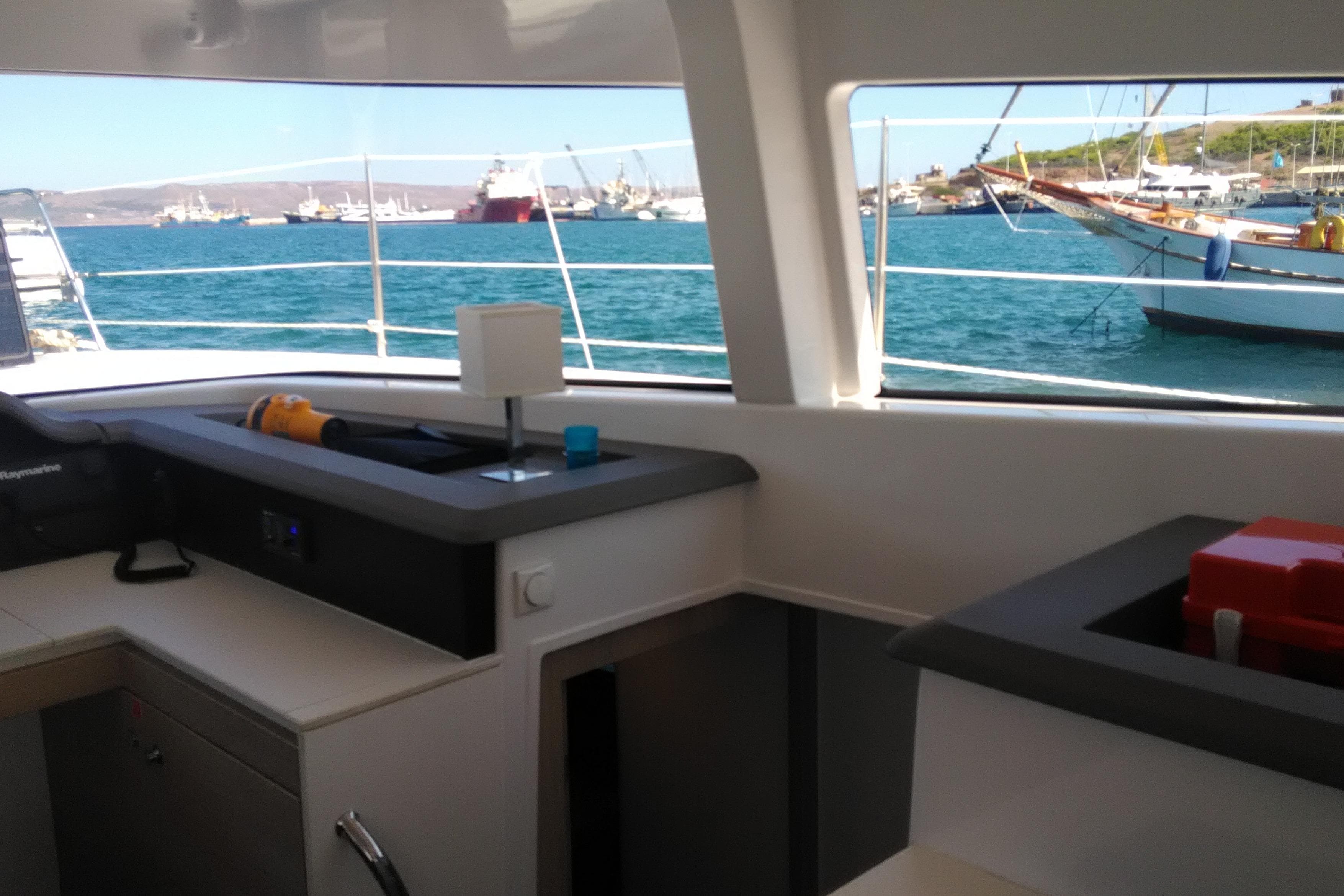 Interior view of a 2018 Bali 4.1 catamaran with ocean and boats outside.