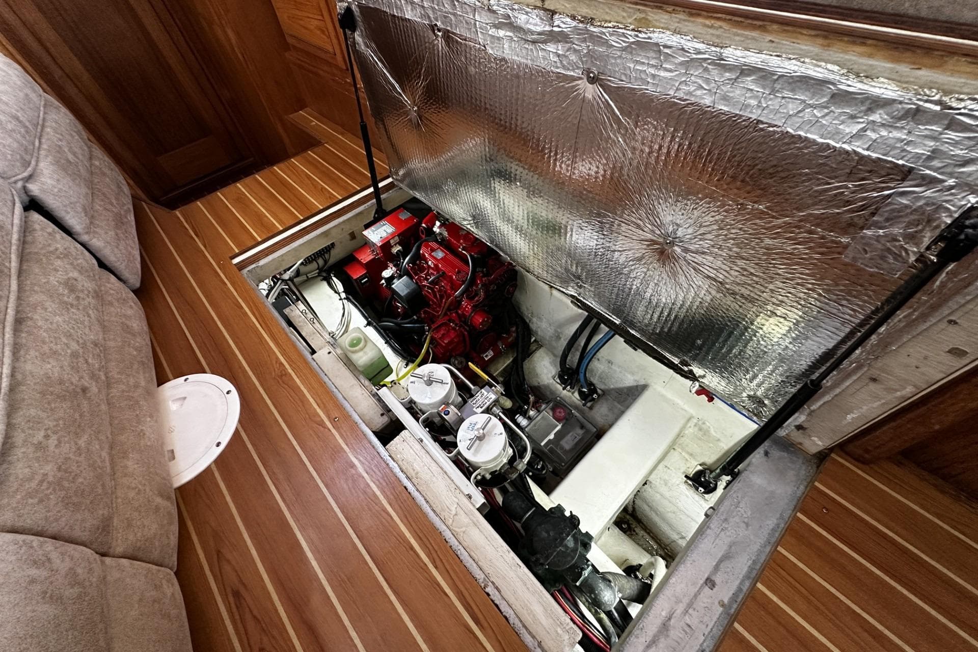 Engine compartment of 2005 Catalina Morgan 440 sailboat, featuring a well-maintained engine and components.