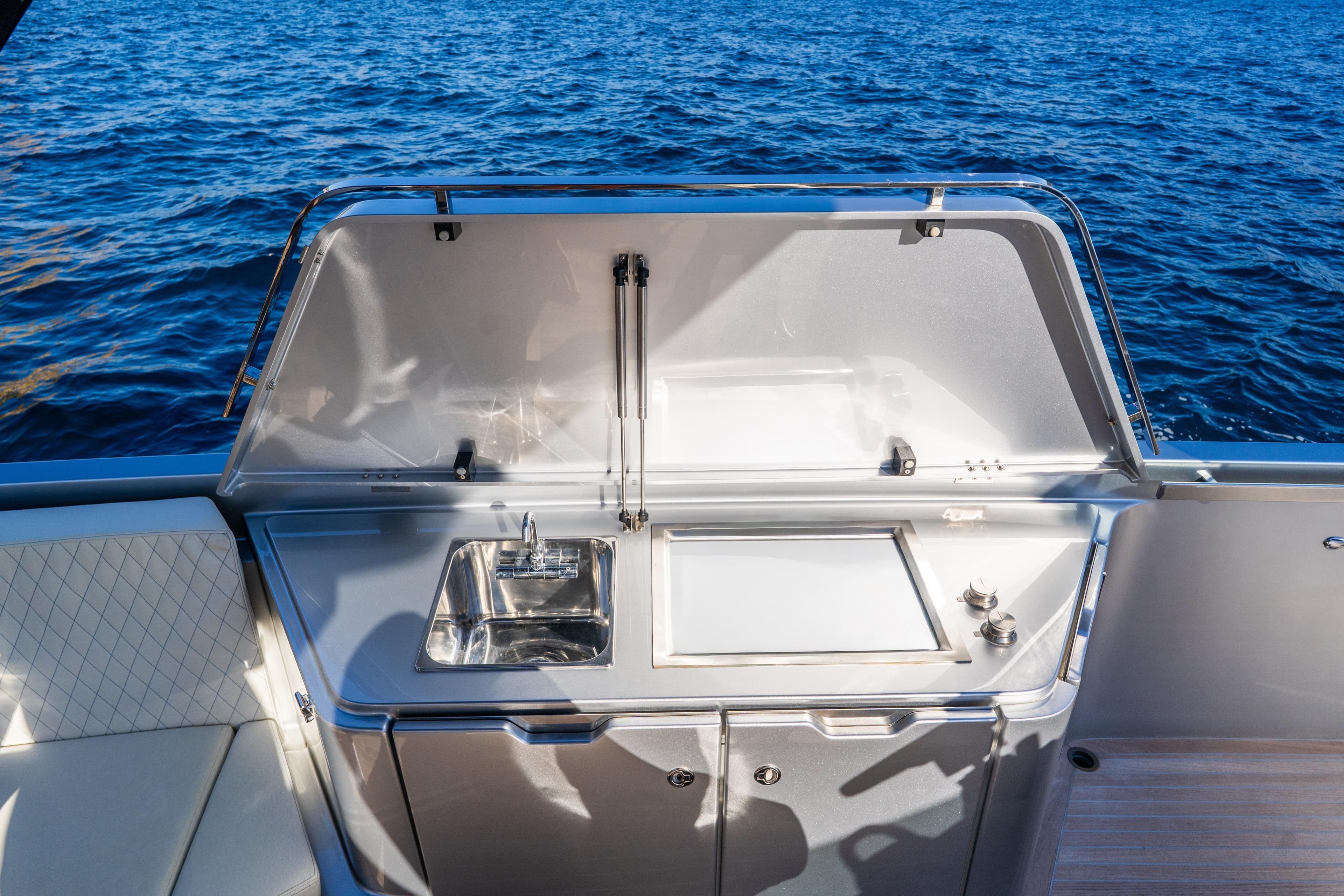 2019 Frauscher 1414 Demon Air yacht with outdoor kitchen and sink by the sea.