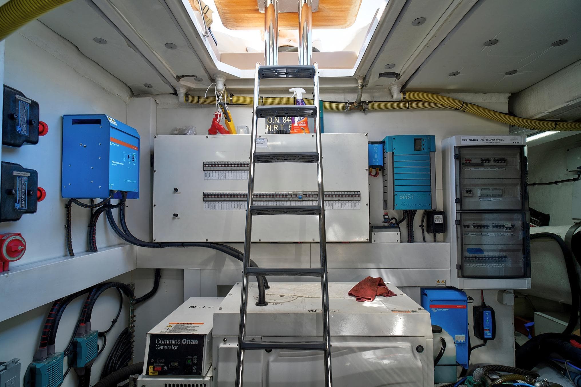 Engine room of 2021 Fairline Squadron 68 yacht with electrical panels and generator.