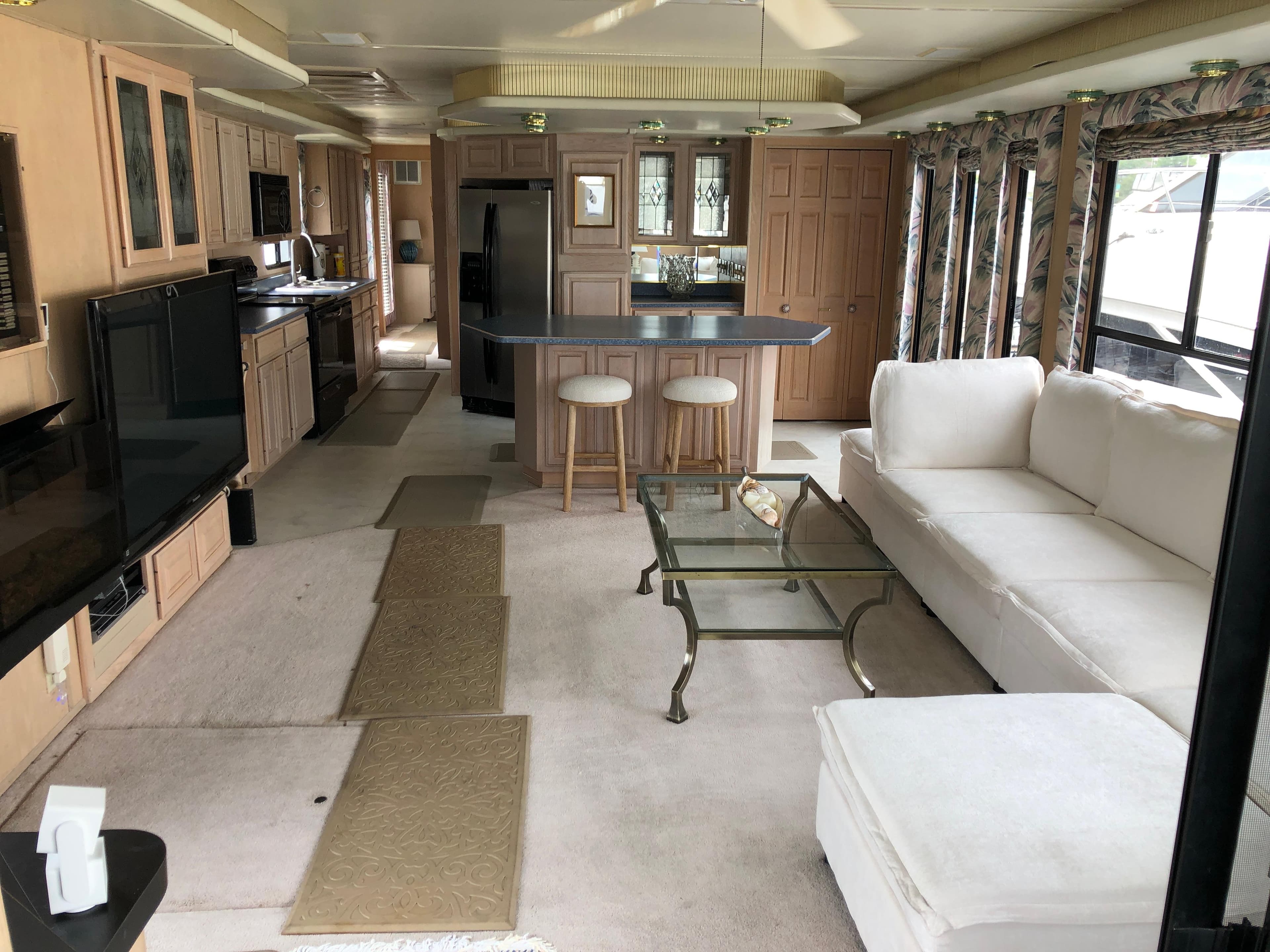 Luxurious interior of a 1997 Sumerset 75' X 16' houseboat with modern kitchen and cozy living area.