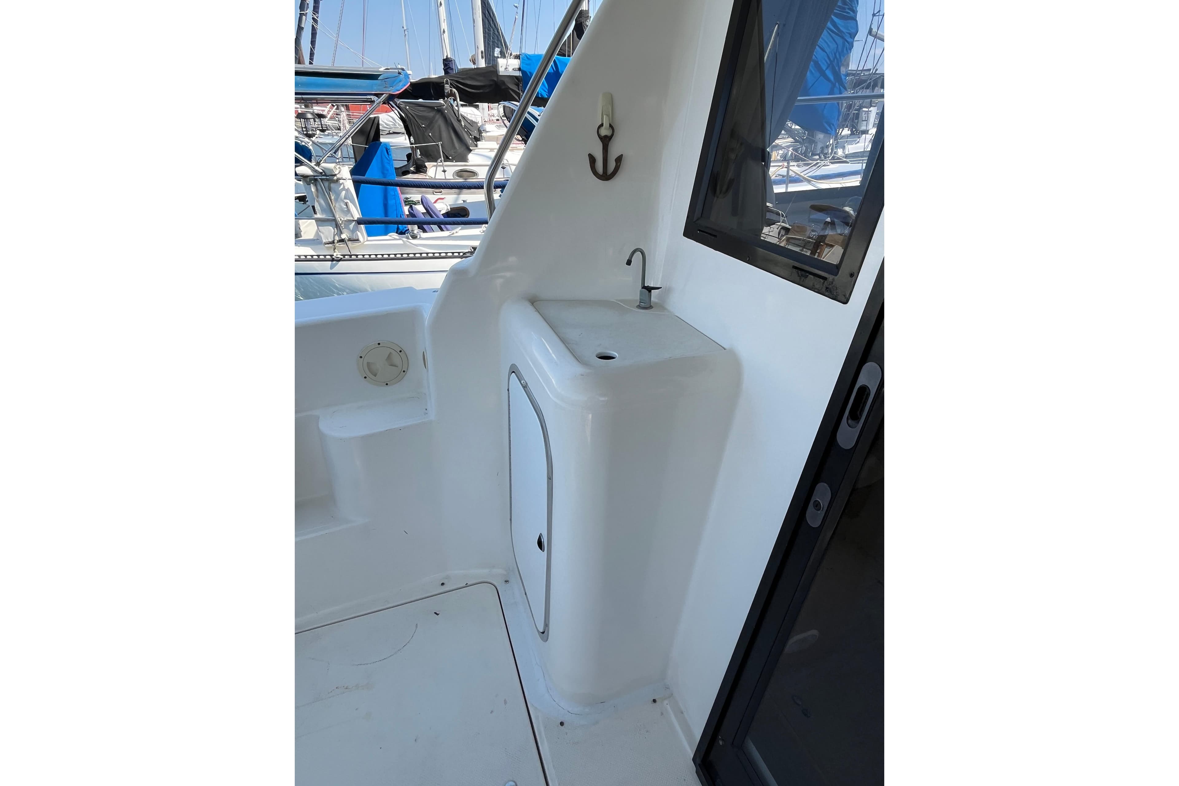 1996 Bayliner 3788 Command Bridge Motoryacht sink area with window and anchor hook.