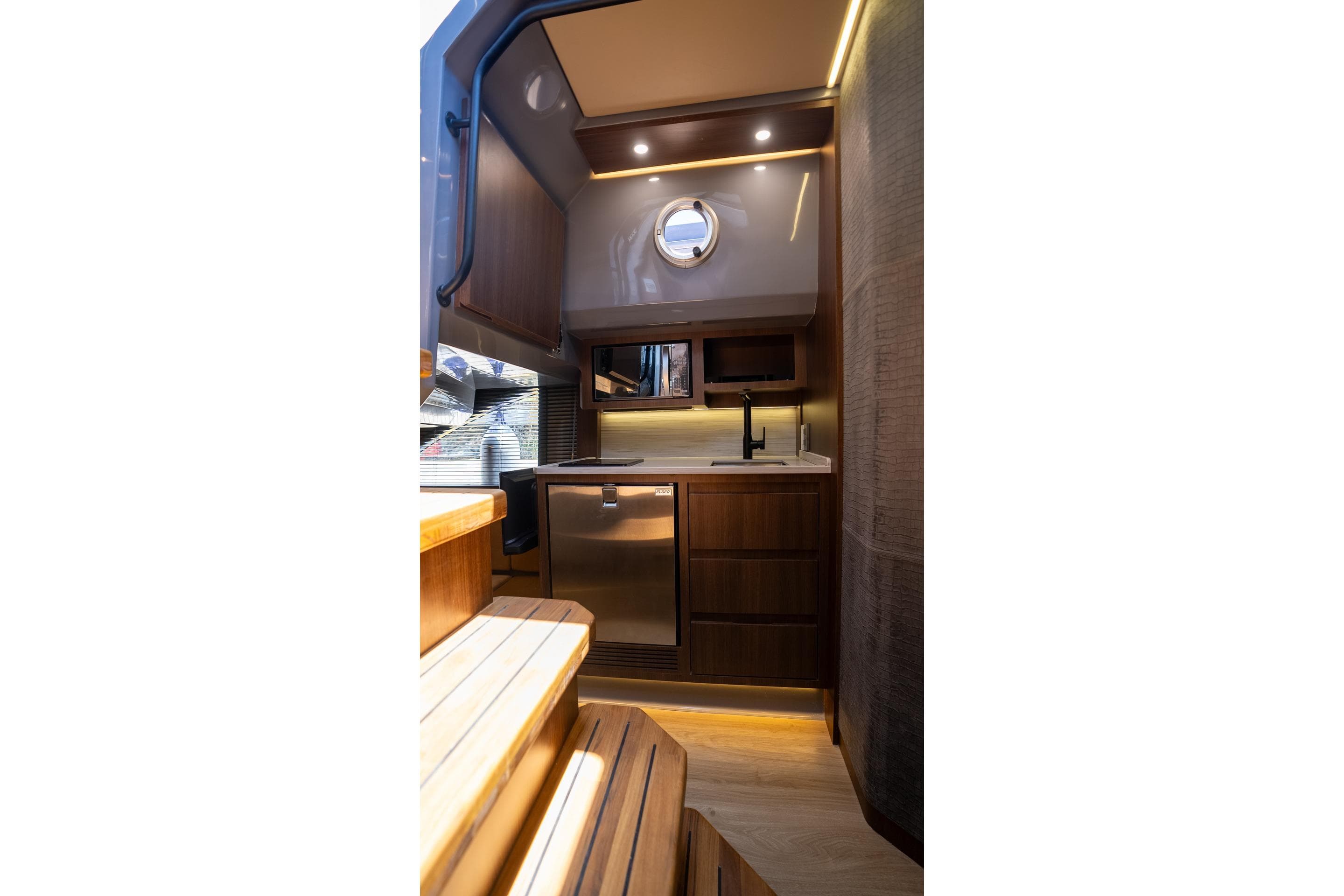 Luxurious interior of 2026 Hanover 447 yacht with modern kitchen and wooden finishes.
