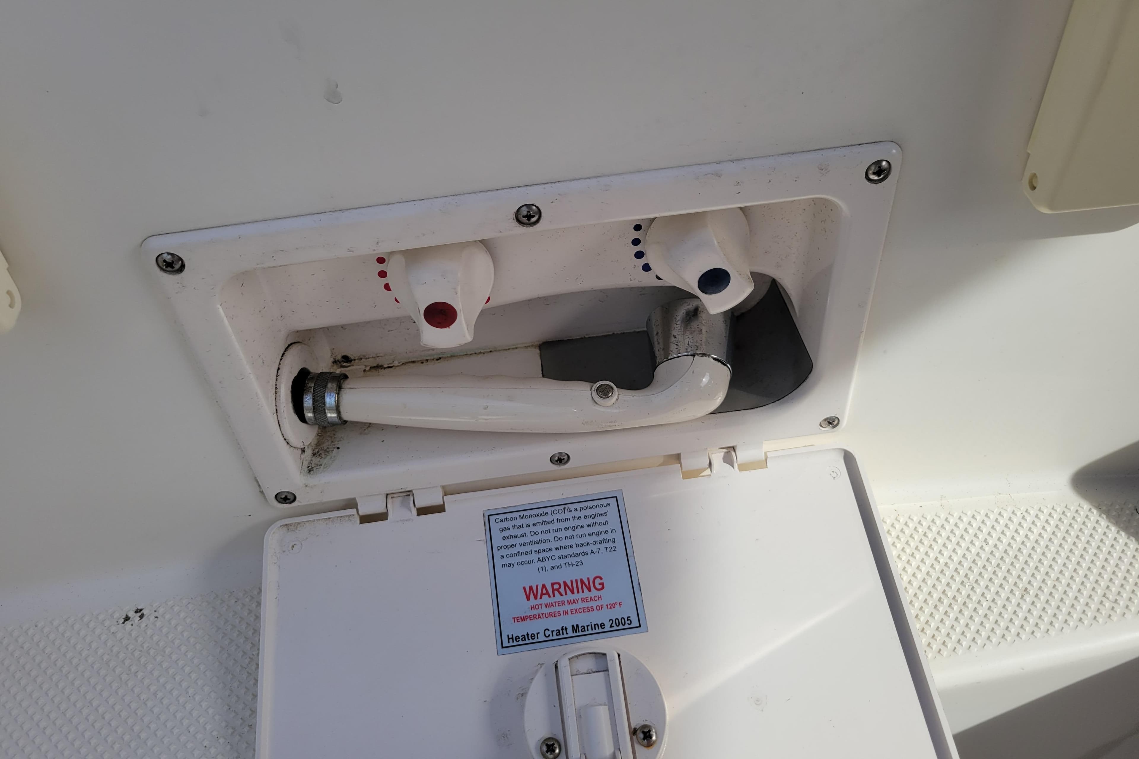 2007 Bayliner 245 Cruiser shower compartment with hot and cold water controls.