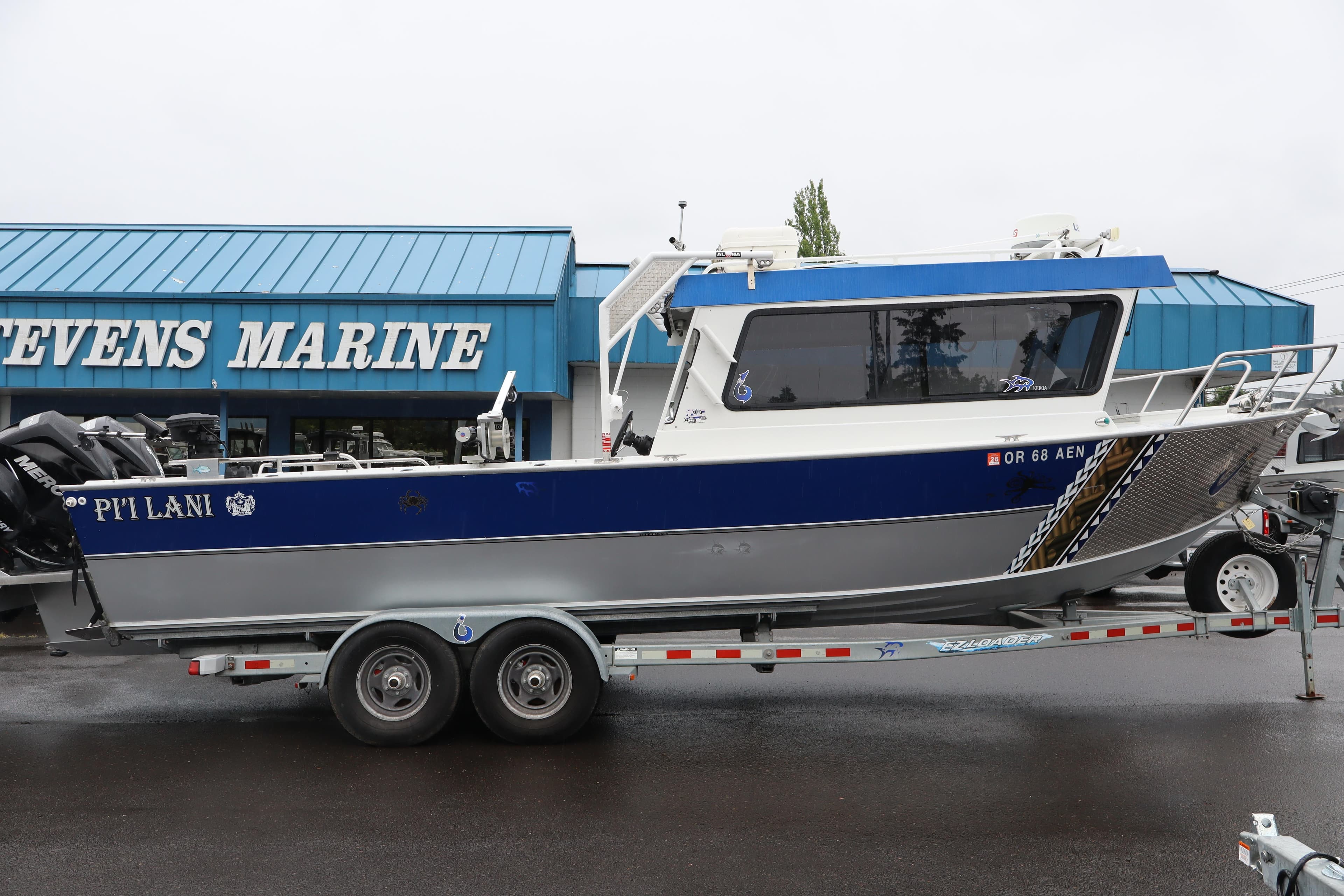 2012 Alumaweld Pacific 27 boat on trailer at Stevens Marine dealership.