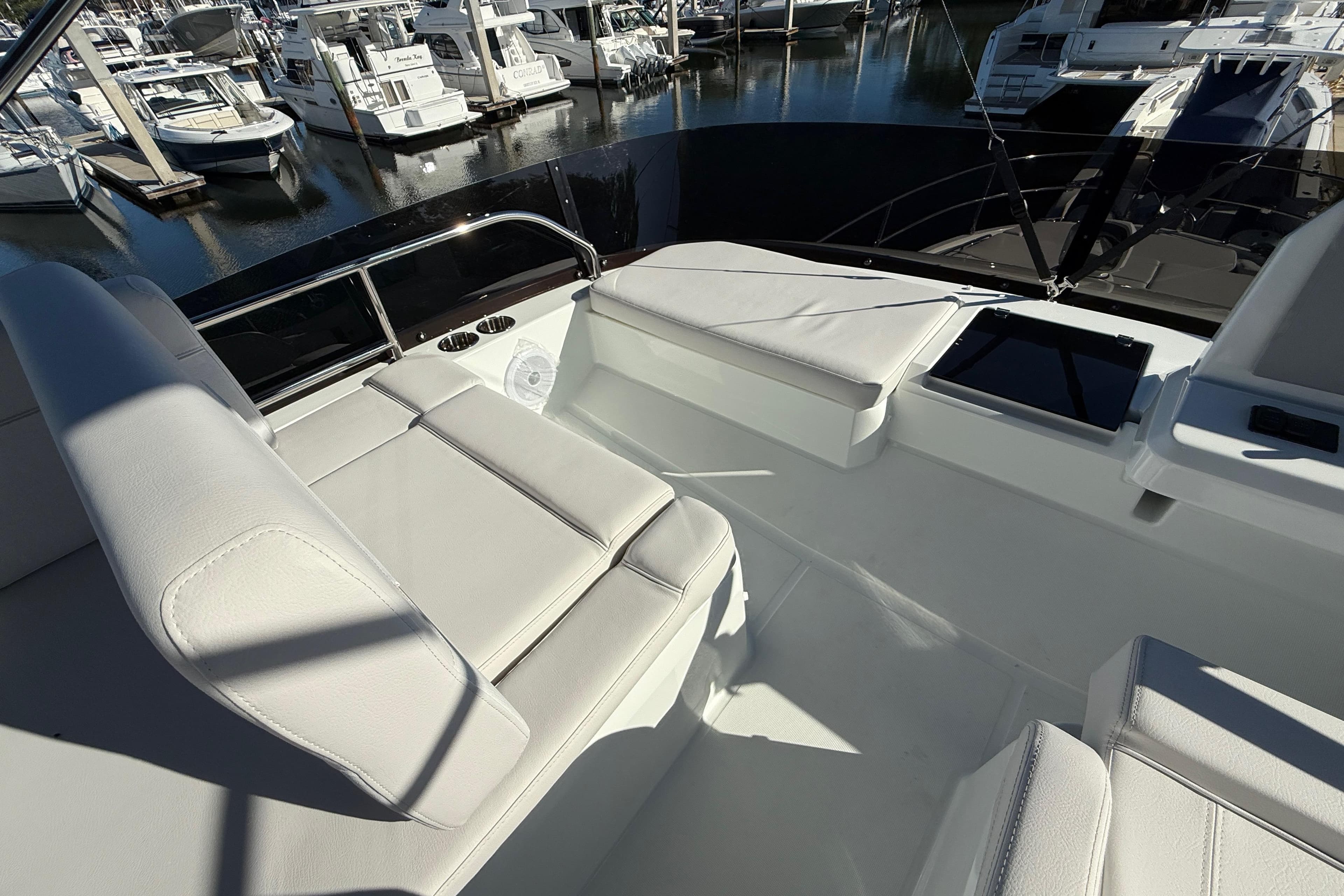 2026 Beneteau Antares 12 yacht interior with white seating at marina.