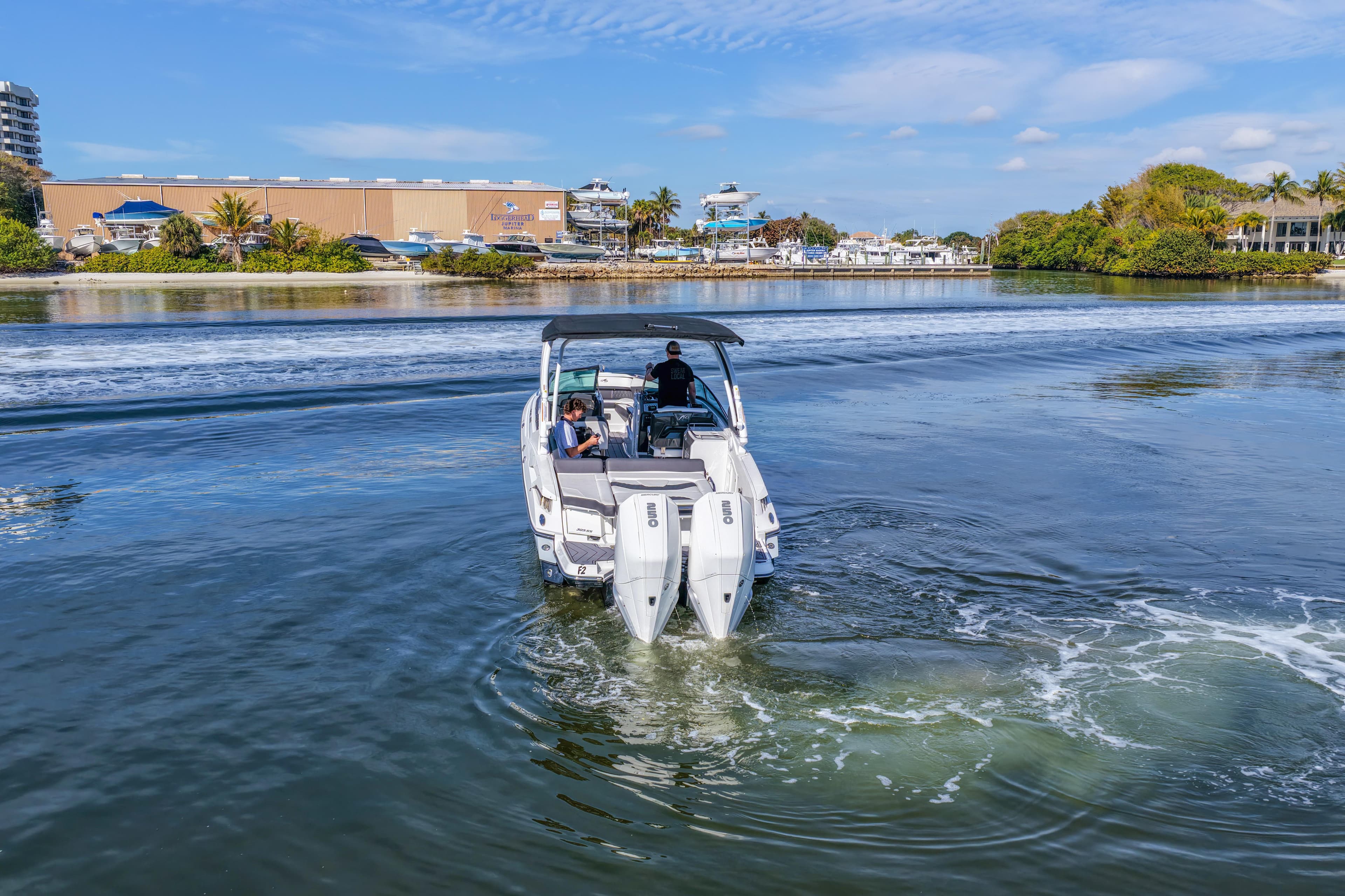 2023 Monterey 305SS Super Sport boat cruising on a scenic waterway.