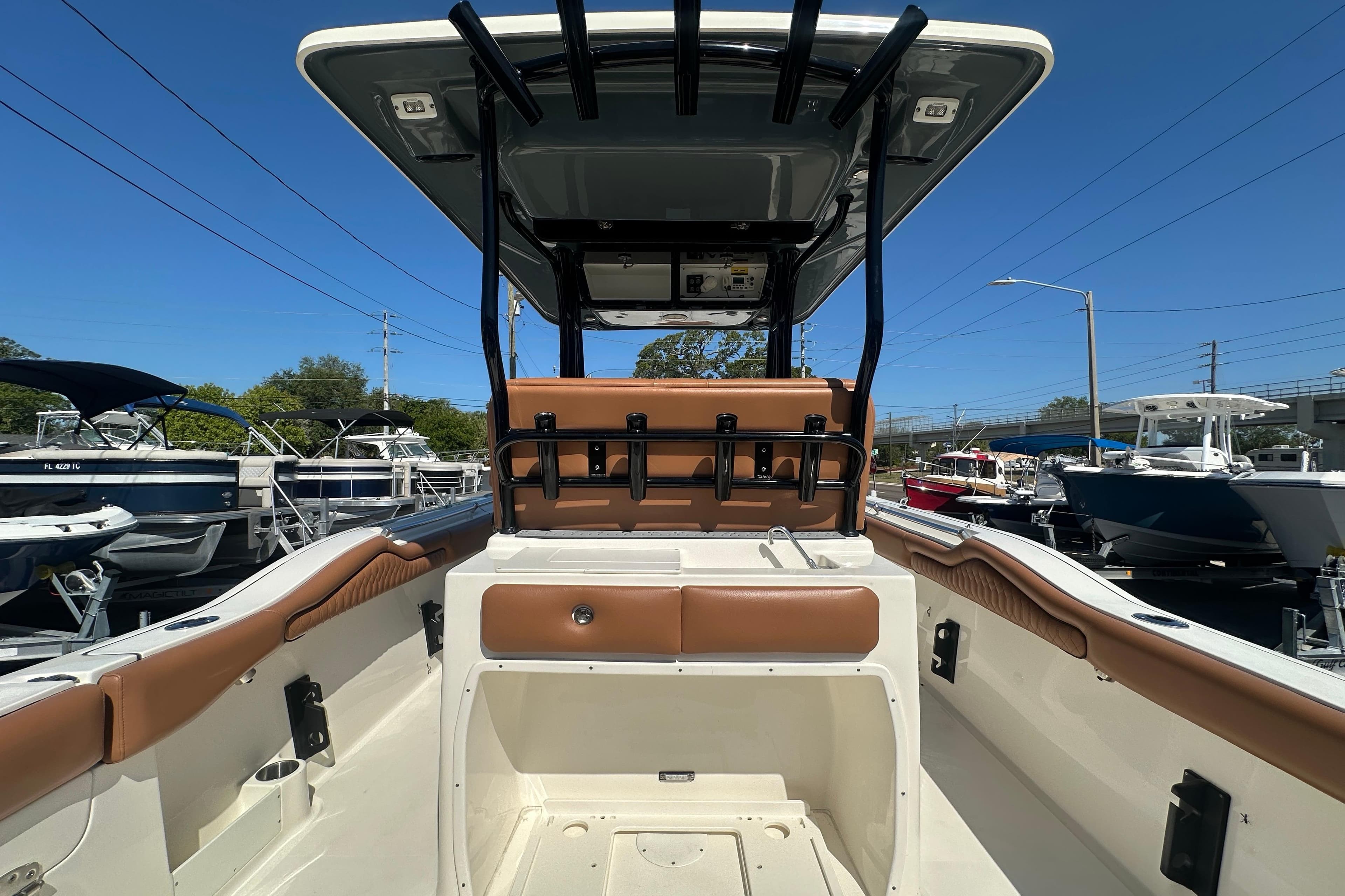 2021 Key West 263 FS boat interior with seating and storage, docked under clear blue sky.