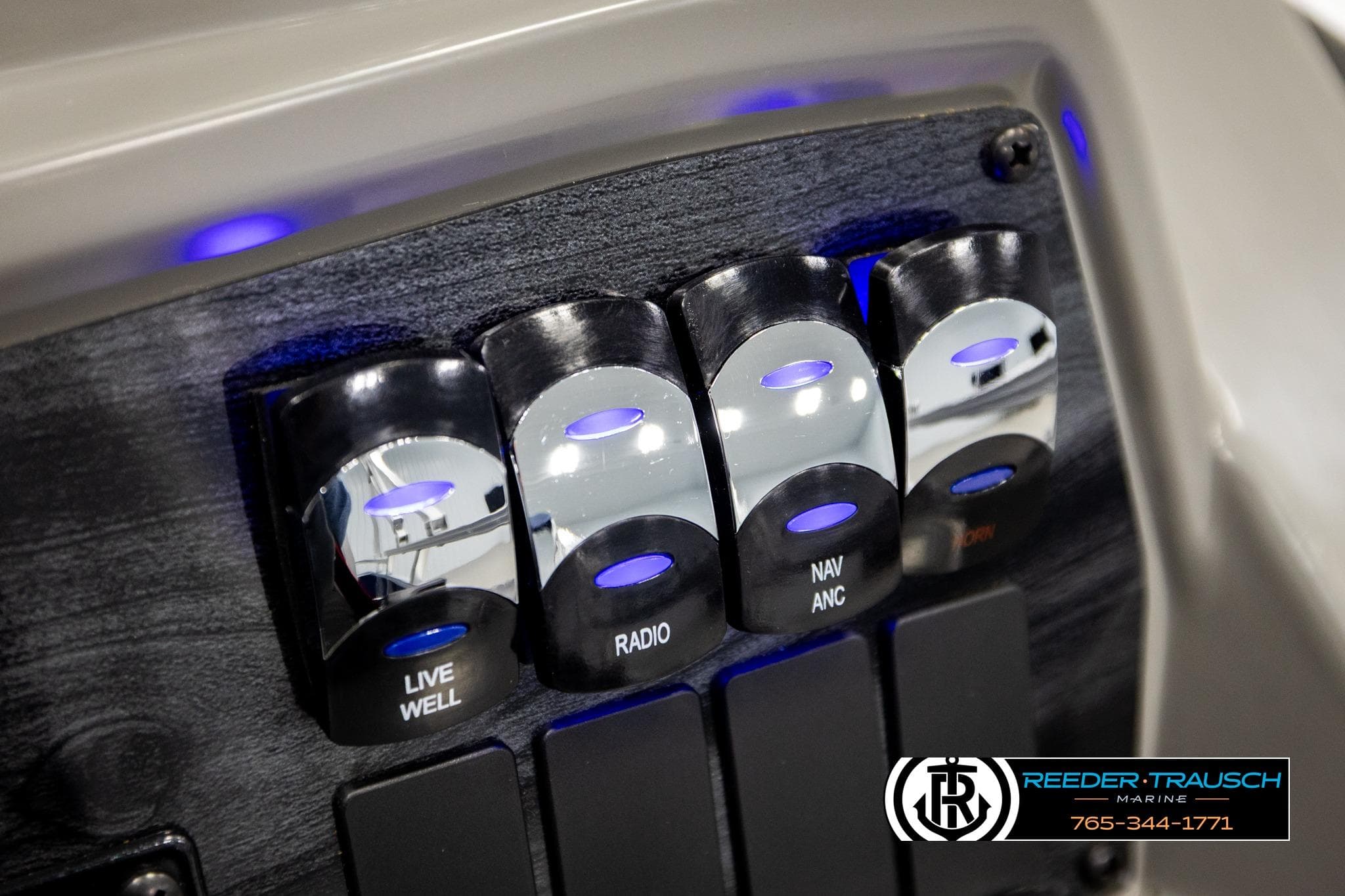 Control panel of 2026 Avalon VEN RF boat with illuminated switches for live well, radio, and navigation.