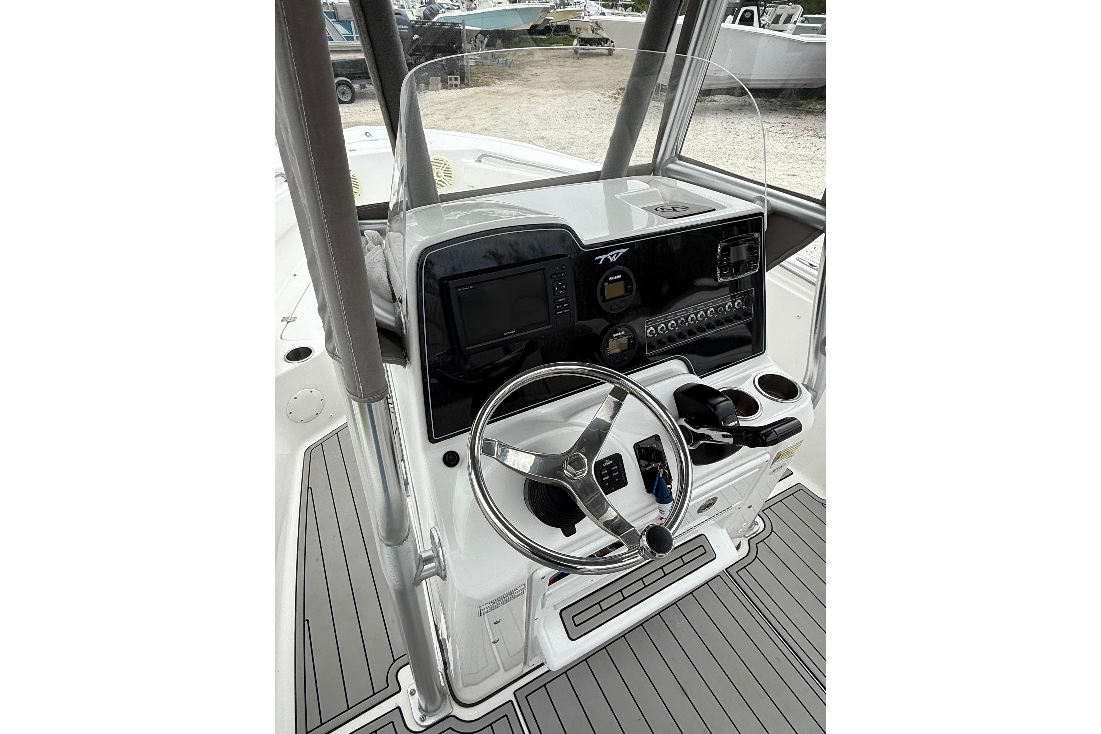 Helm of 2016 Tidewater 210 LXF boat with steering wheel and control panel.