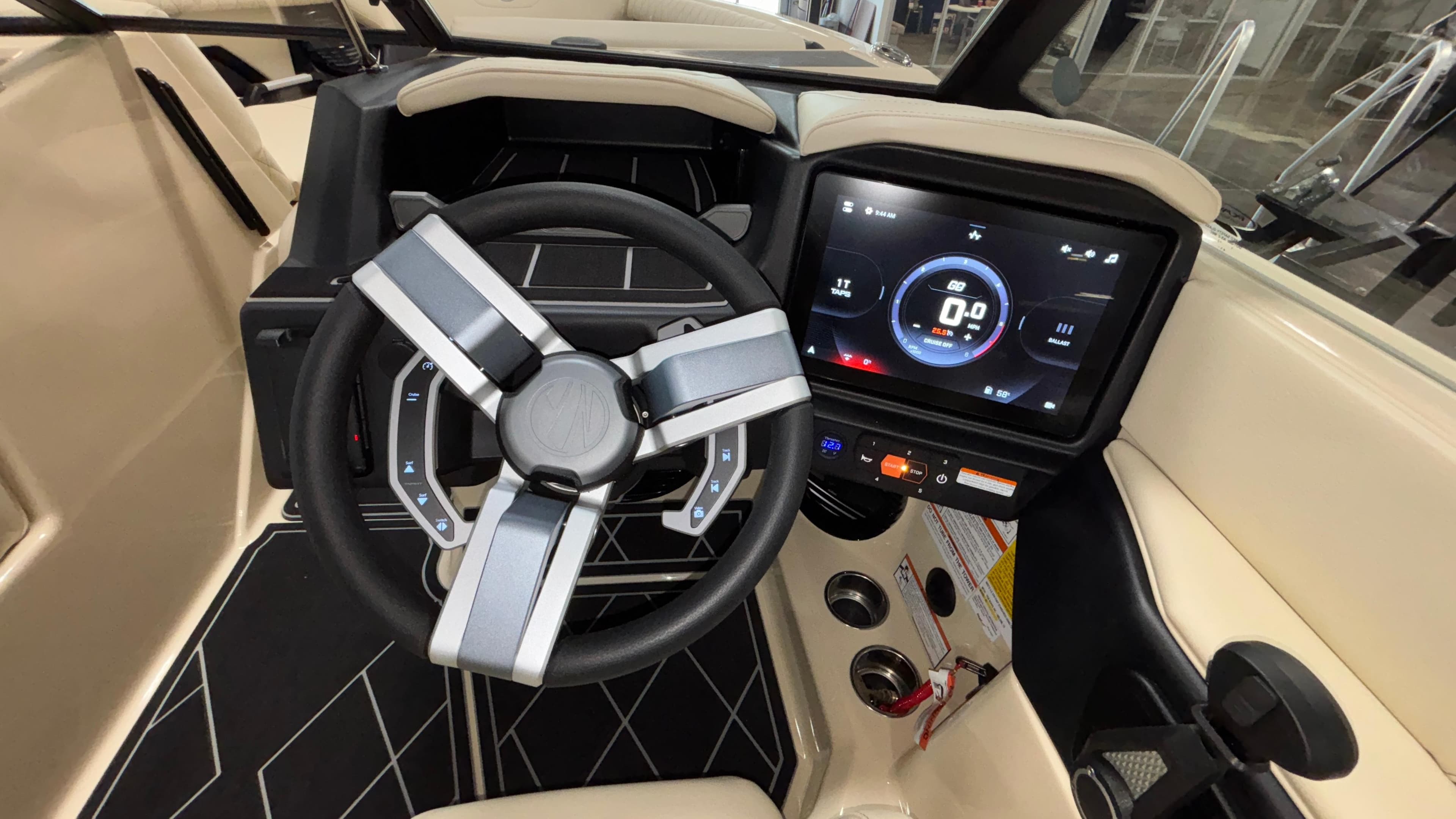 2025 Tigé Z5 boat dashboard with modern steering wheel and digital display.