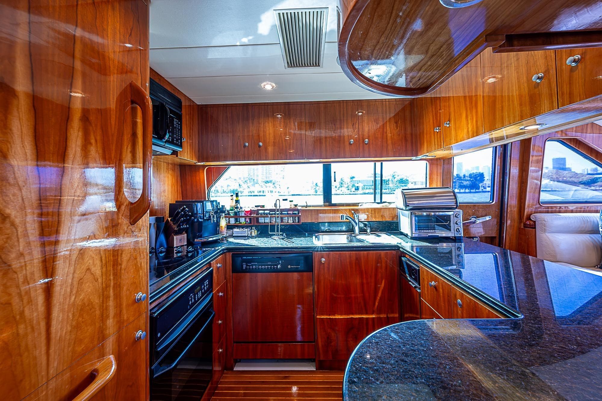 Luxurious yacht kitchen with wooden cabinetry and modern appliances, Horizon 82, year 2000.