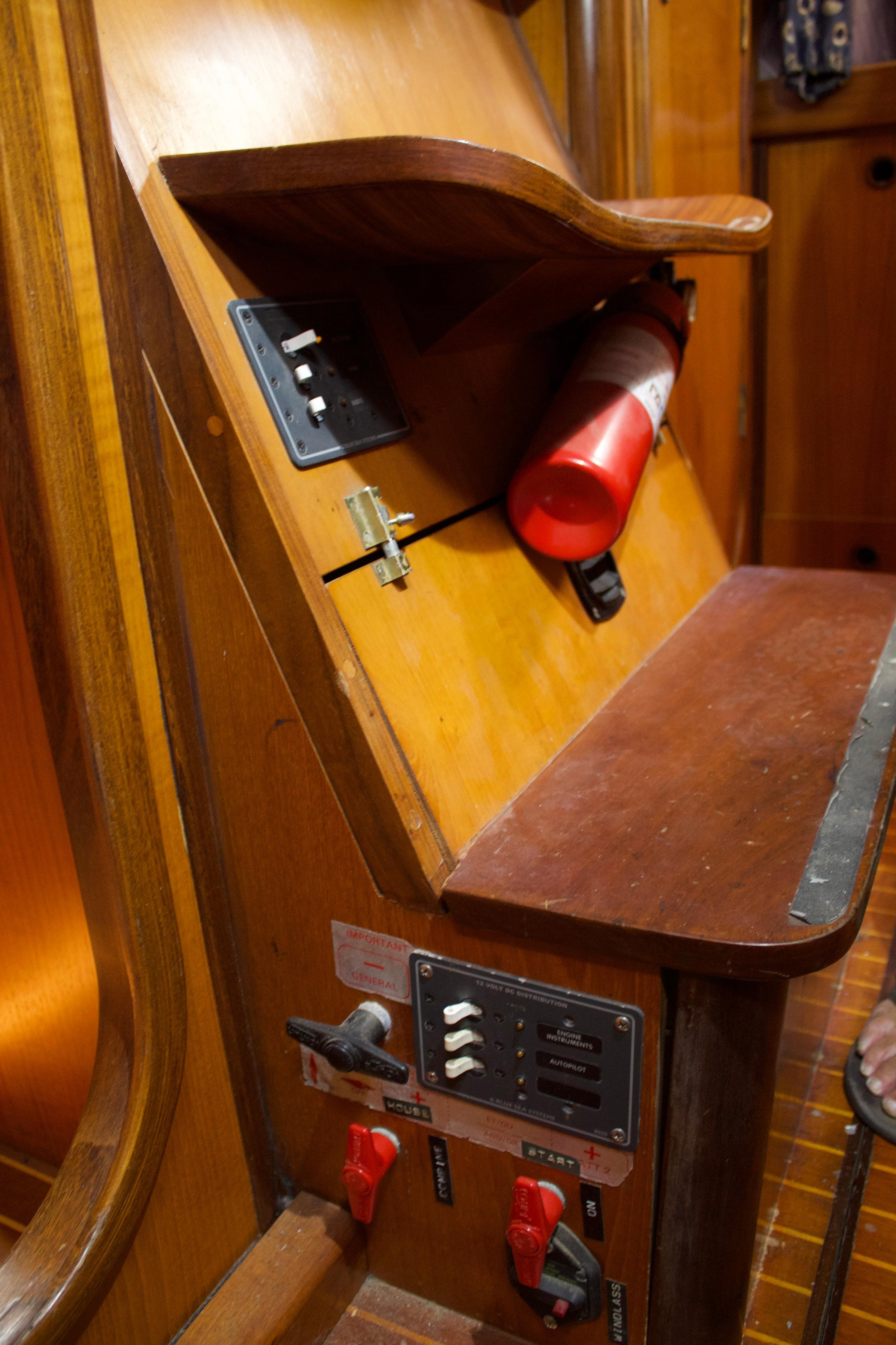 Control panel and fire extinguisher inside 1988 Beneteau First 405 Tall Rig sailboat.