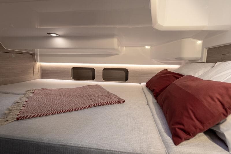 Manufacturer Provided Image: 2026 Jeanneau Leader 9.0 WA Series 2 cabin interior with cozy bedding and ambient lighting.