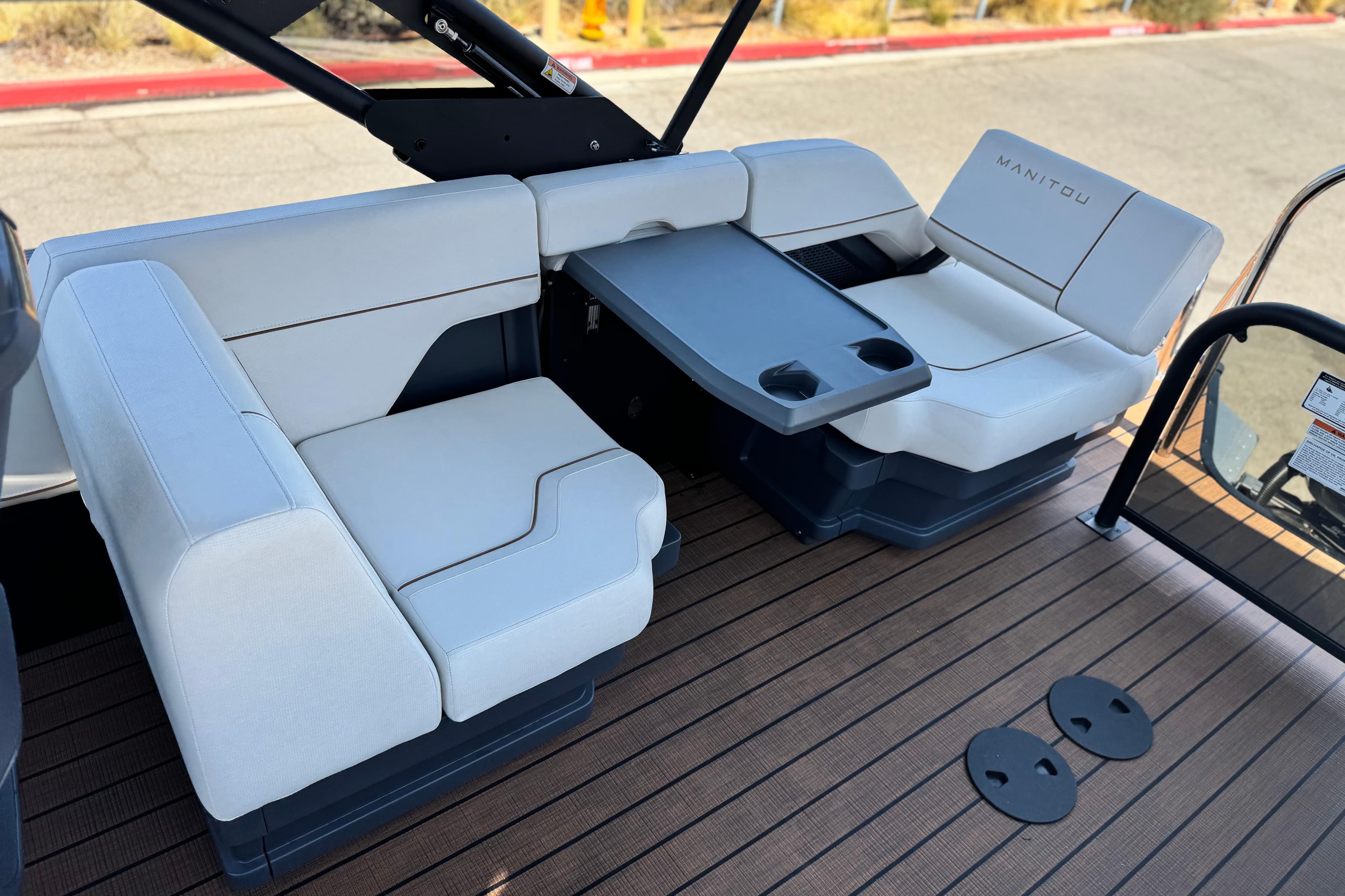 Luxurious seating on 2025 Manitou EXPLORE 26 boat with sleek design and modern amenities.