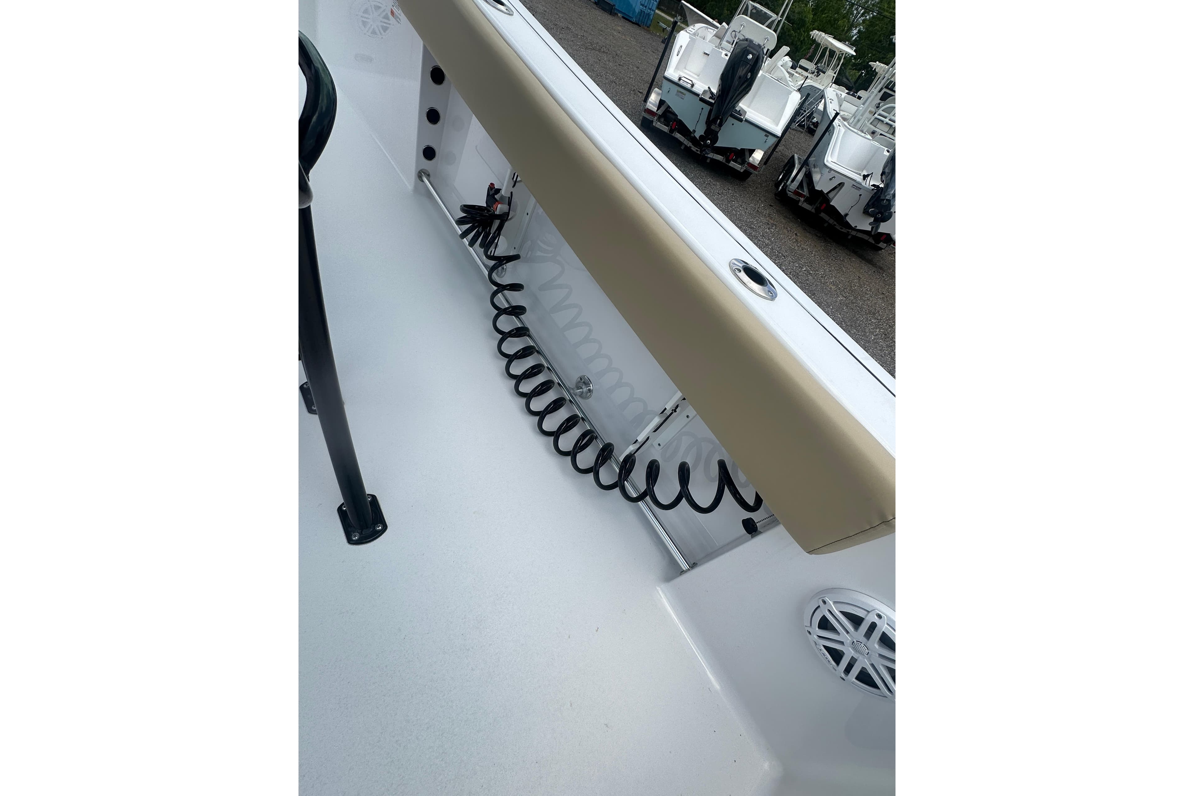 2026 Sportsman Open 232 Center Console boat interior with coiled hose and speaker.