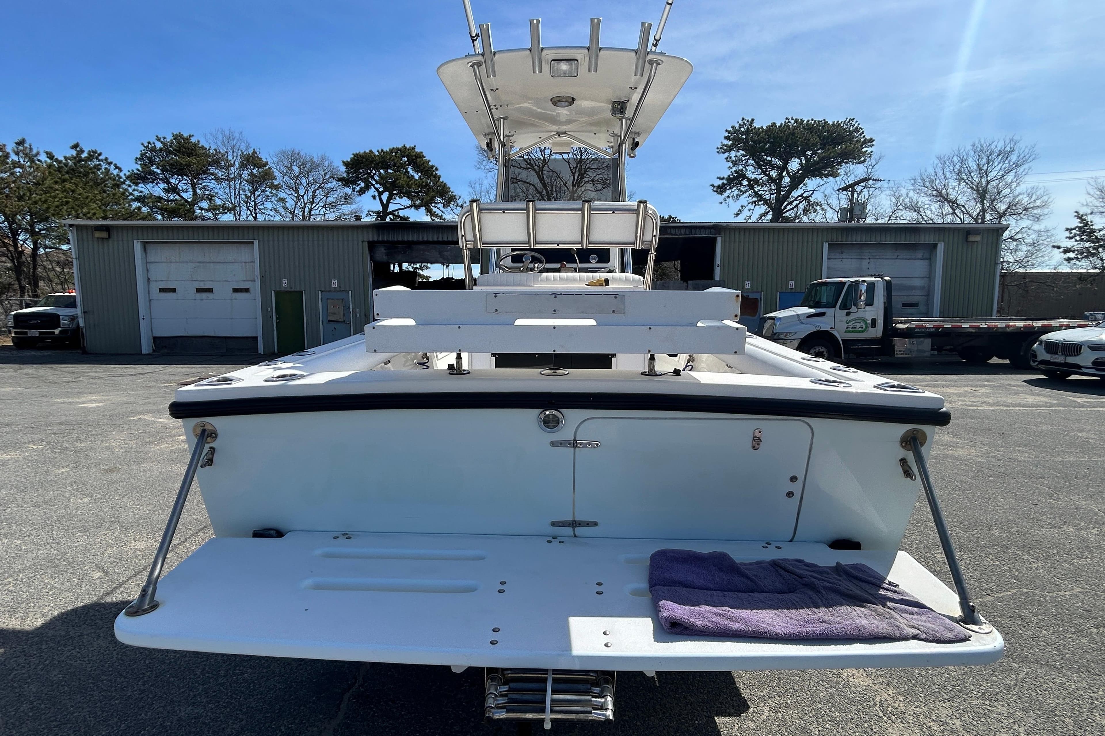 2006 Albin 26 Center Console boat, rear view in a parking lot, sunny day.