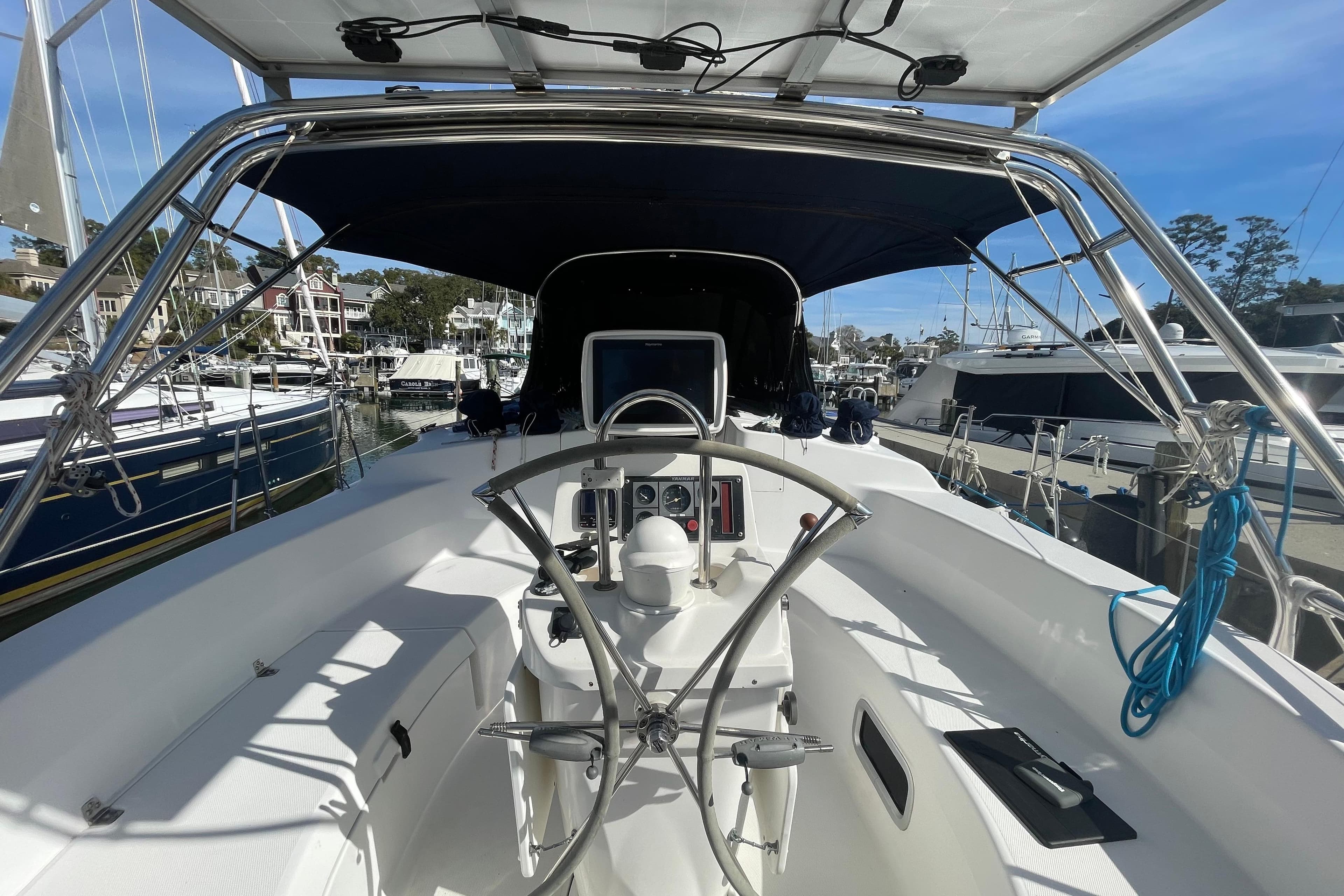Cockpit view of 1999 Hunter 460 sailboat docked in a marina.