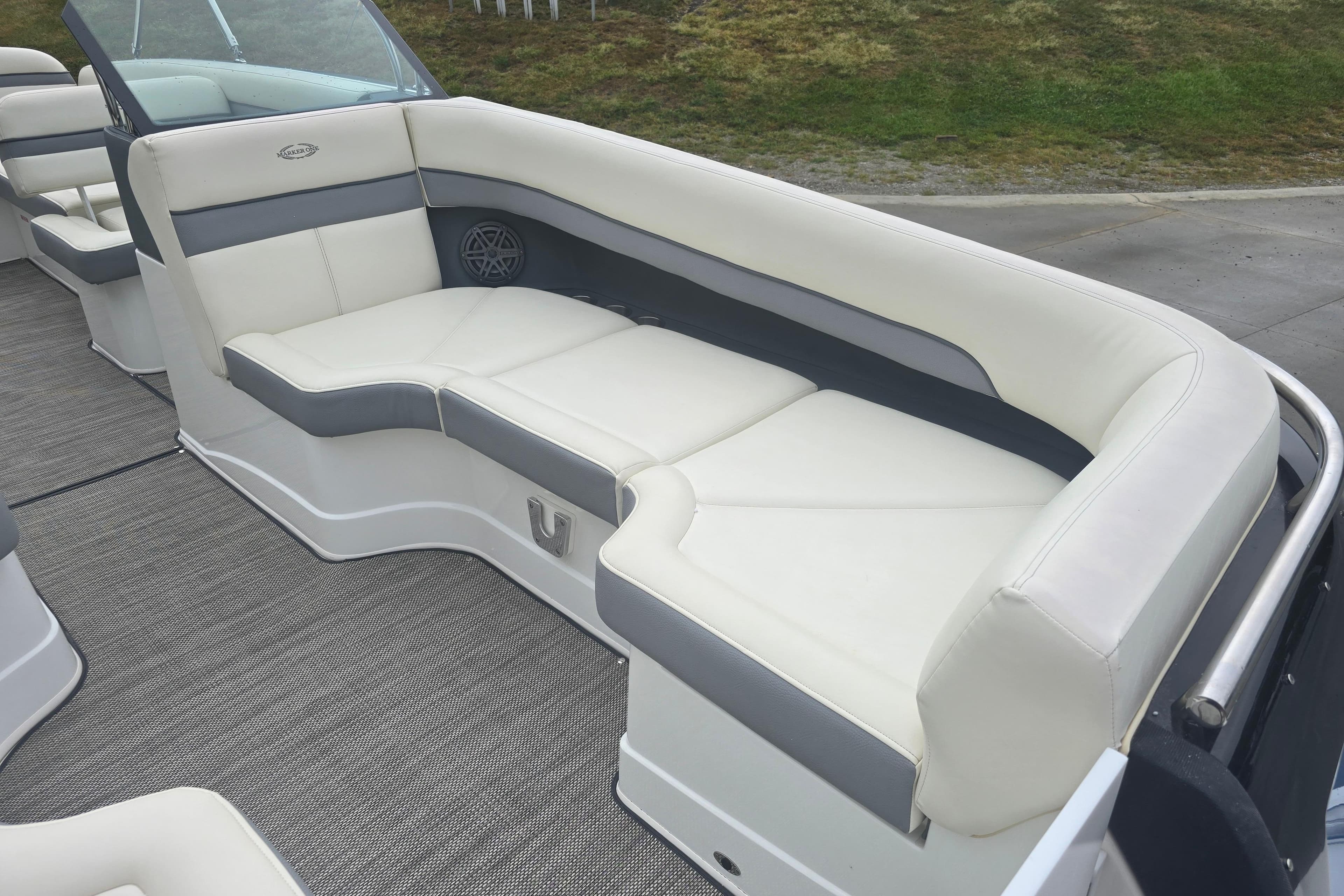 Luxurious seating on a 2016 Marker One ML4 boat, featuring white and gray upholstery.