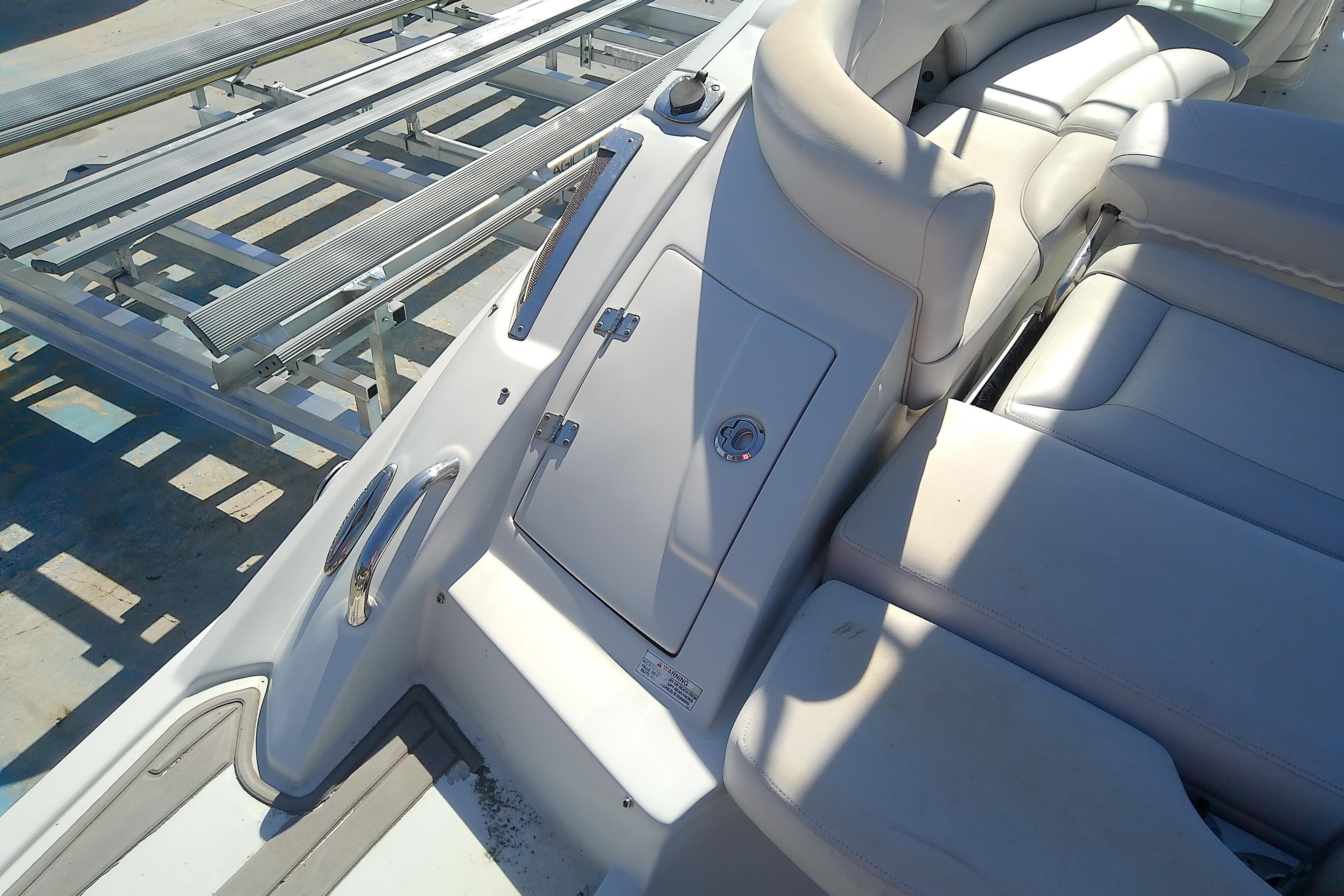 2017 Crownline Eclipse E6 XS boat interior with white seating and storage compartment.