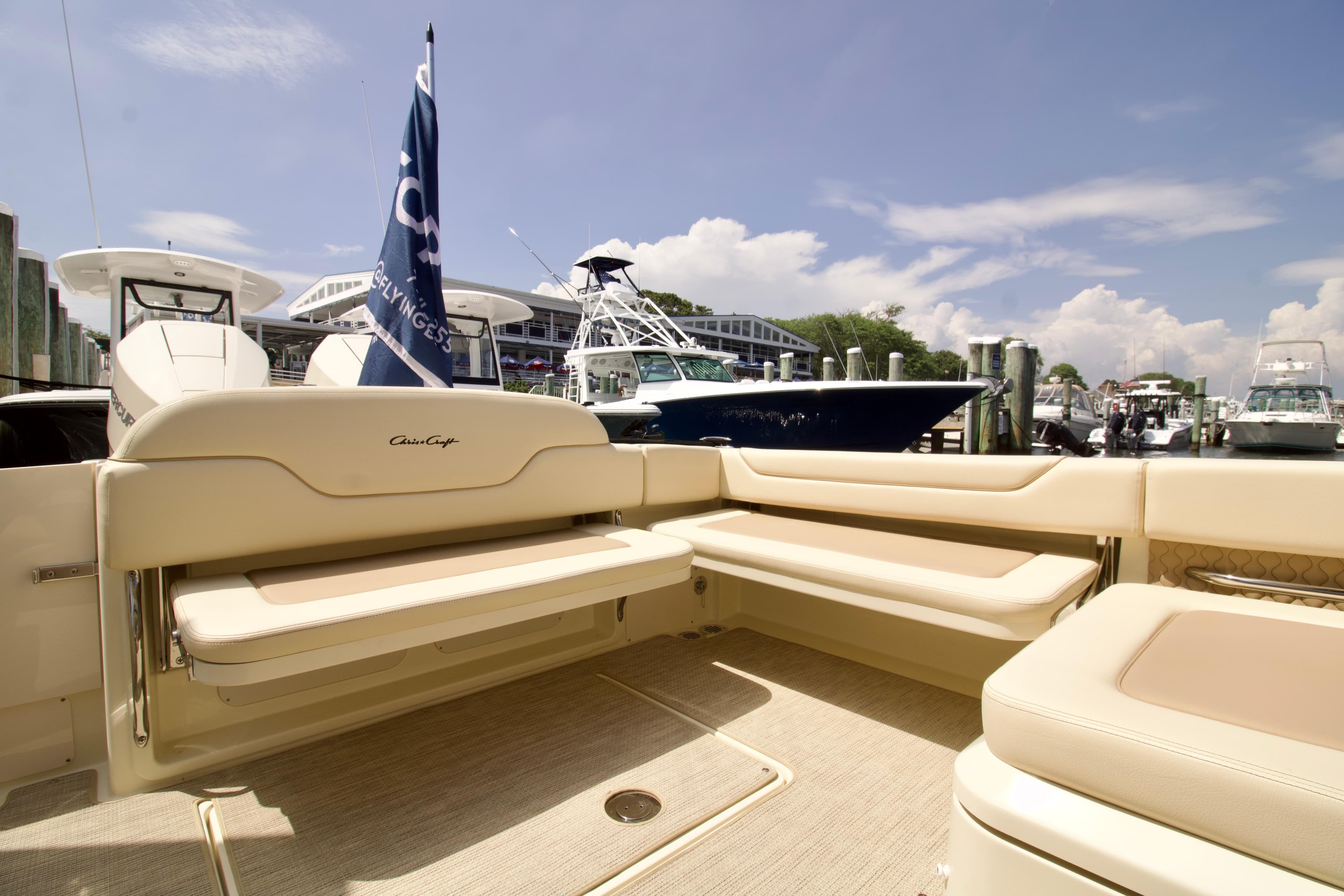 2025 Chris-Craft Calypso 32 boat interior with beige seating at a marina.