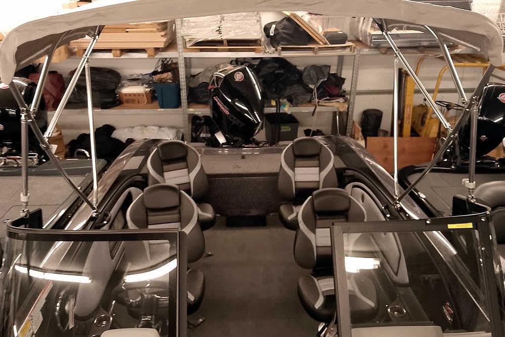 2026 Ranger 2050MS Reata boat interior with seating and canopy in storage.