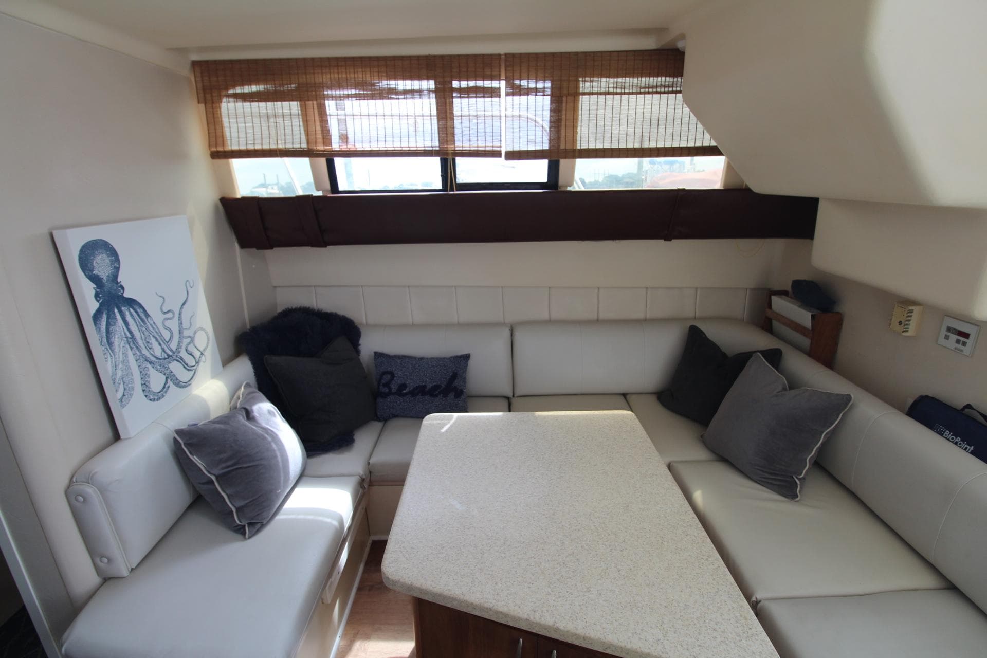Interior of 1999 Mainship 31 Sedan Bridge with cozy seating and nautical decor.