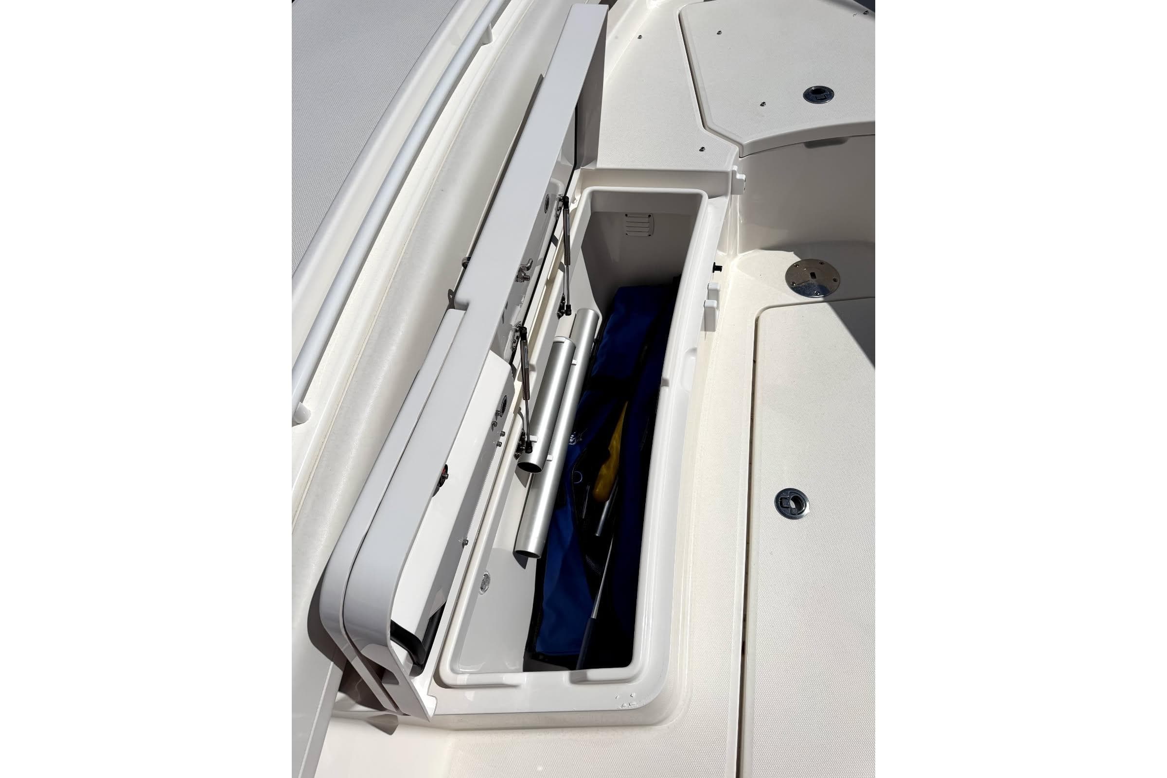 Open storage compartment on 2023 Regulator 28 boat, showcasing interior space and equipment.