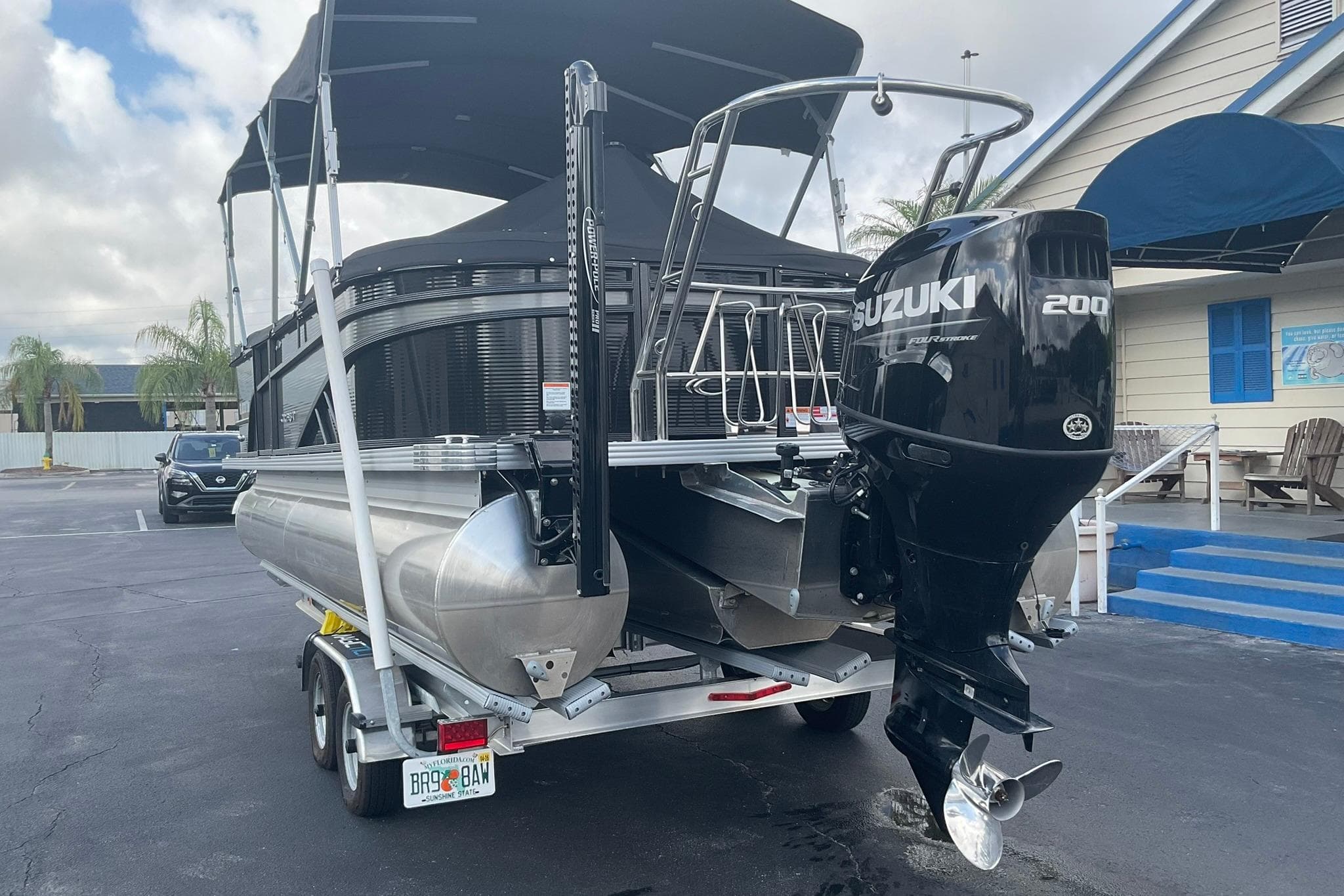 2023 Crest Classic DLX 220 SLC pontoon boat with Suzuki 200 outboard motor.