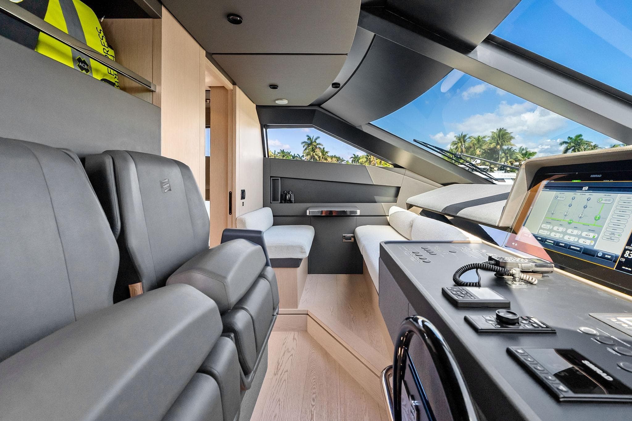 Luxurious interior of 2022 Ferretti Yachts 780 with modern helm and panoramic windows.