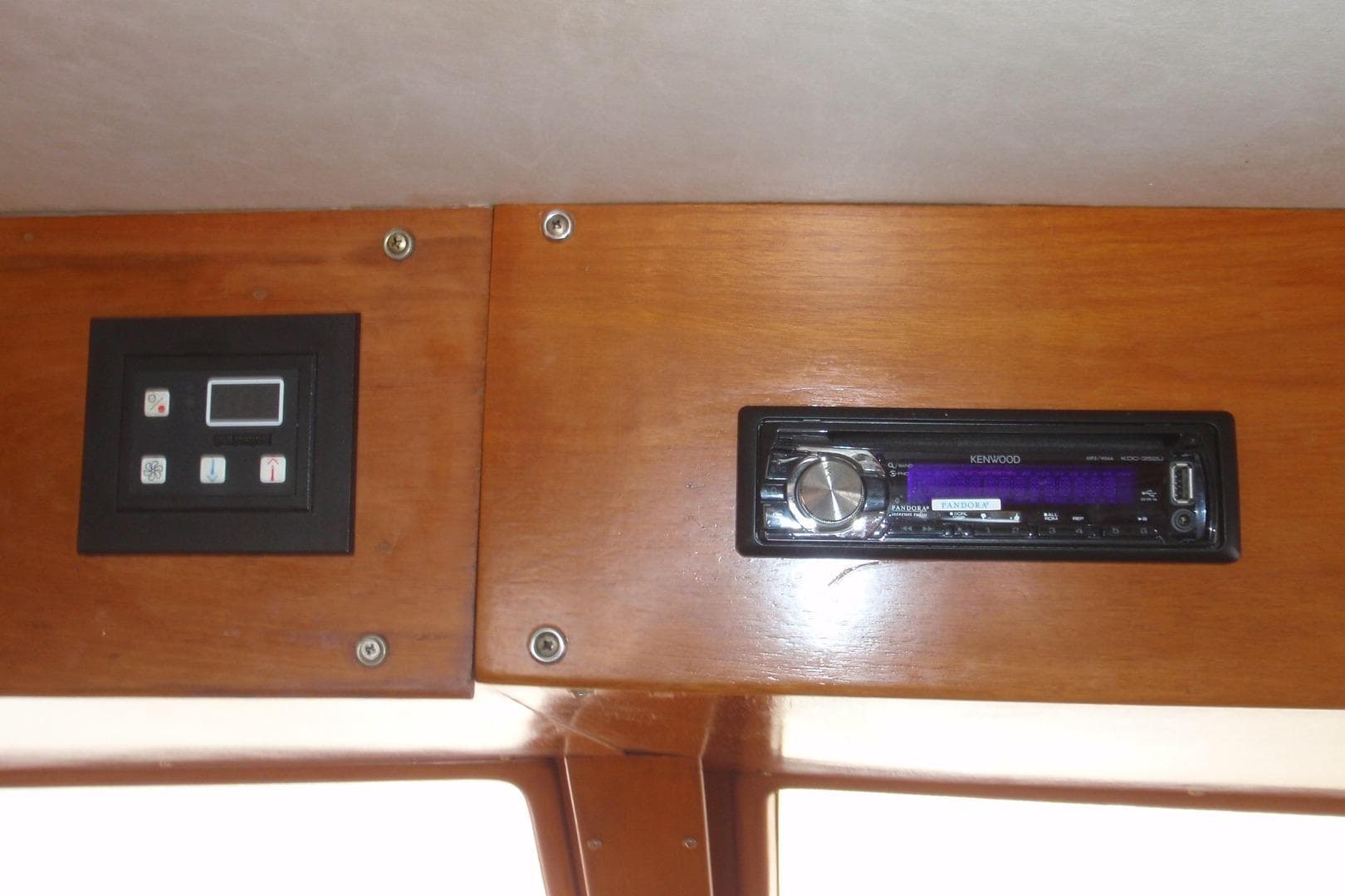 1985 Ocean Alexander interior with Kenwood stereo and control panel on wooden dashboard.