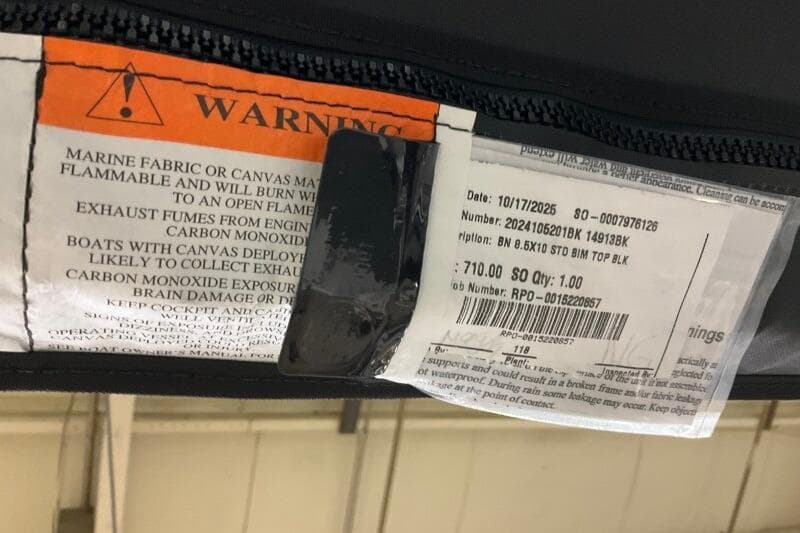 Warning label on Bennington 23 SX L-Bench, 2026 model, highlighting flammability and carbon monoxide risks.