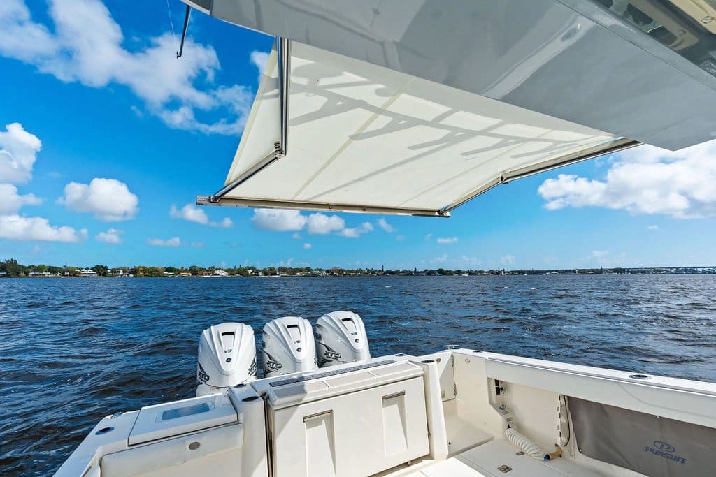 Pursuit S 378 Sport 2021 on open water with sunshade.