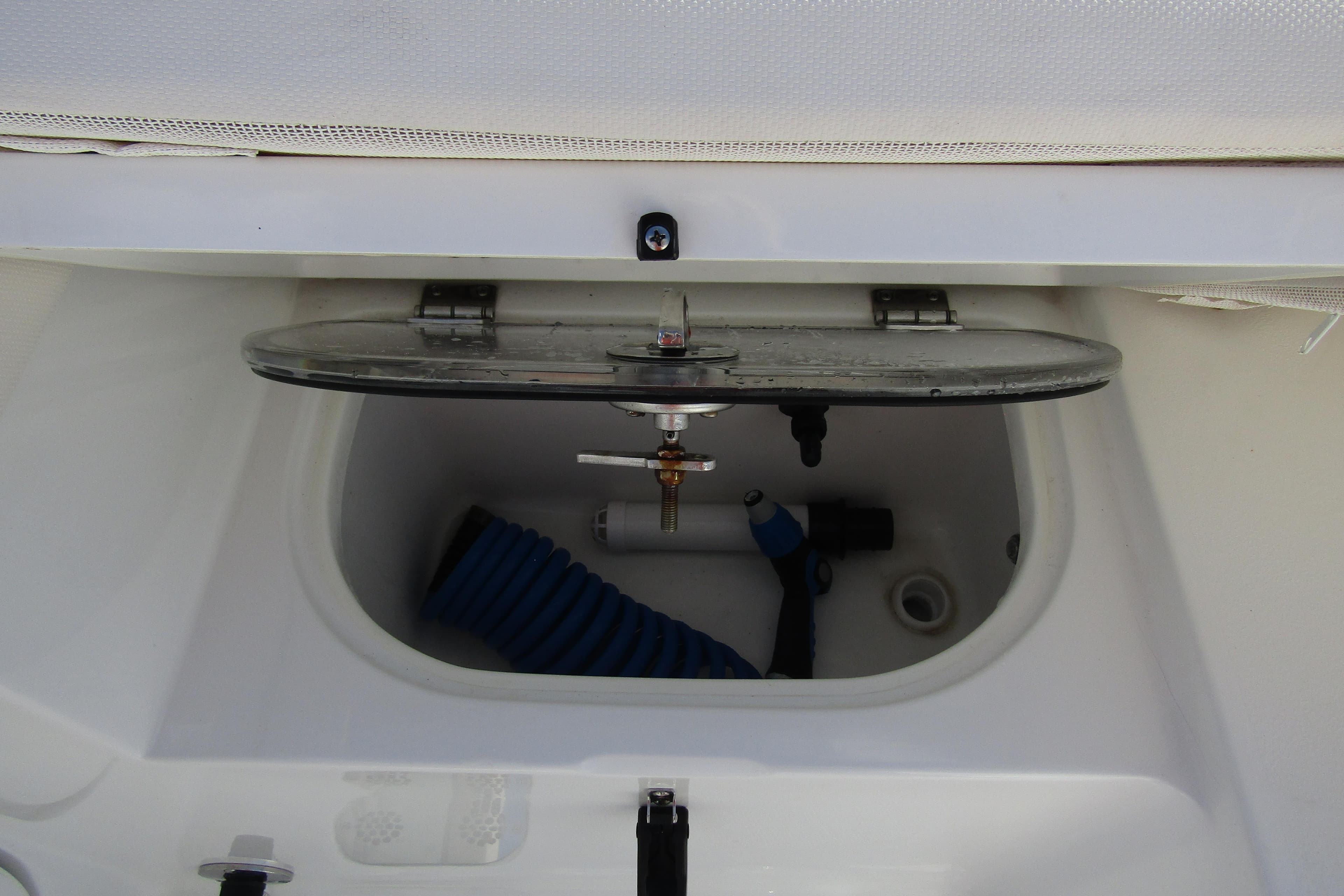 Open storage compartment on 2025 Sea Hunt Ultra 275 SE boat.